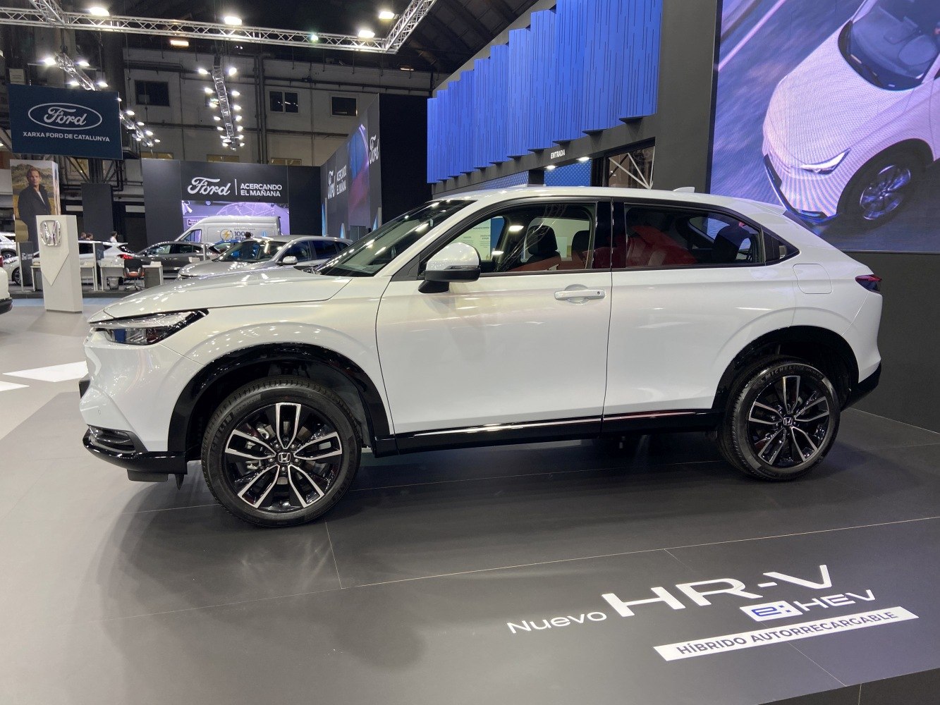 White hybrid SUV side profile with alloy wheels and sleek design