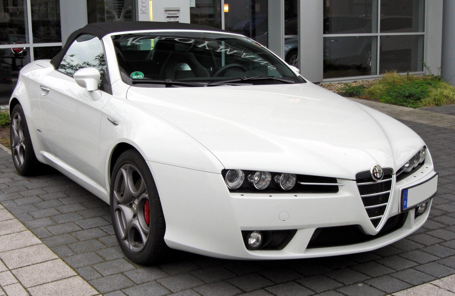 White convertible with triple headlights and Alfa Romeo shield grille