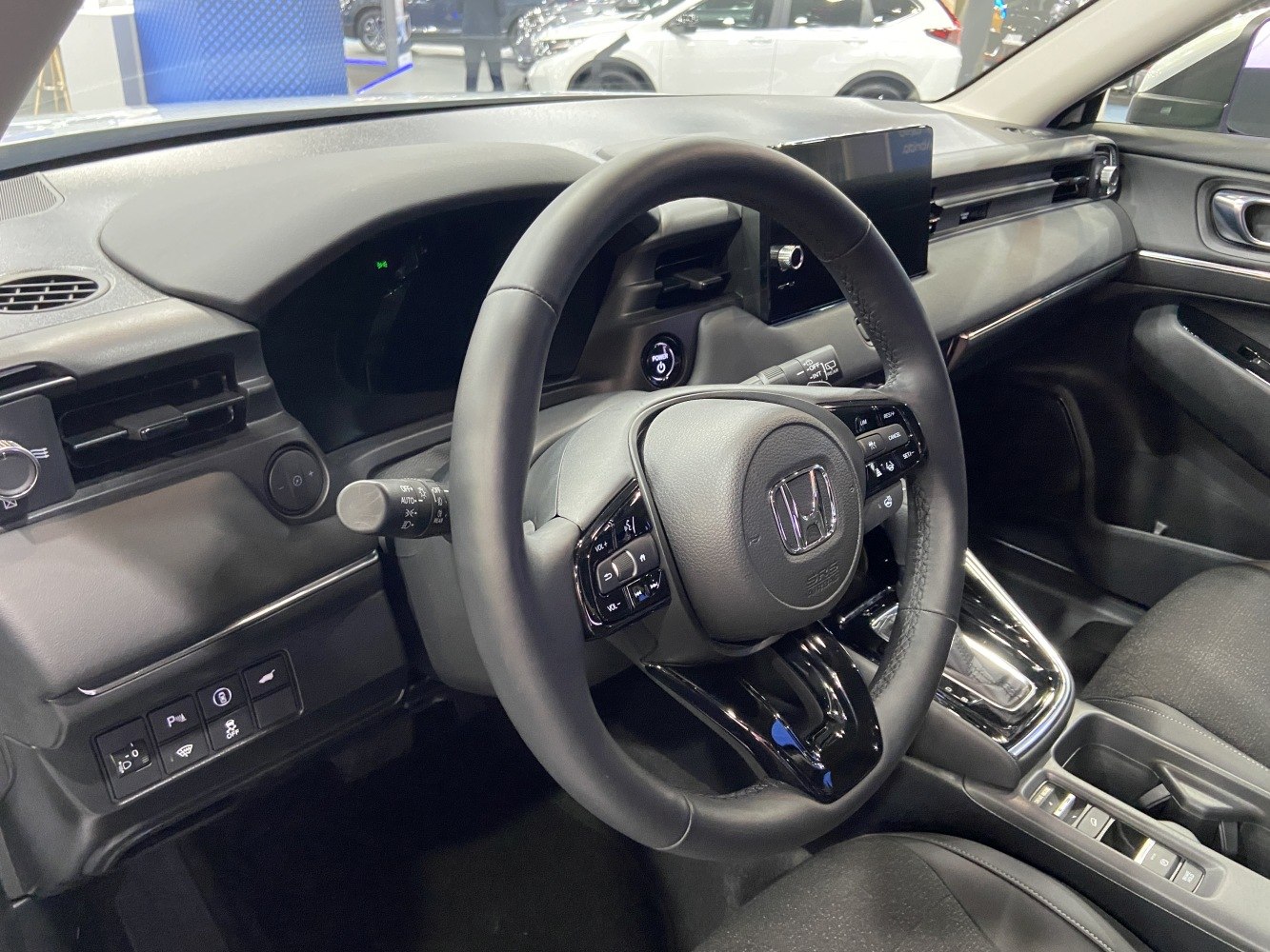 Modern car dashboard with steering wheel and digital controls