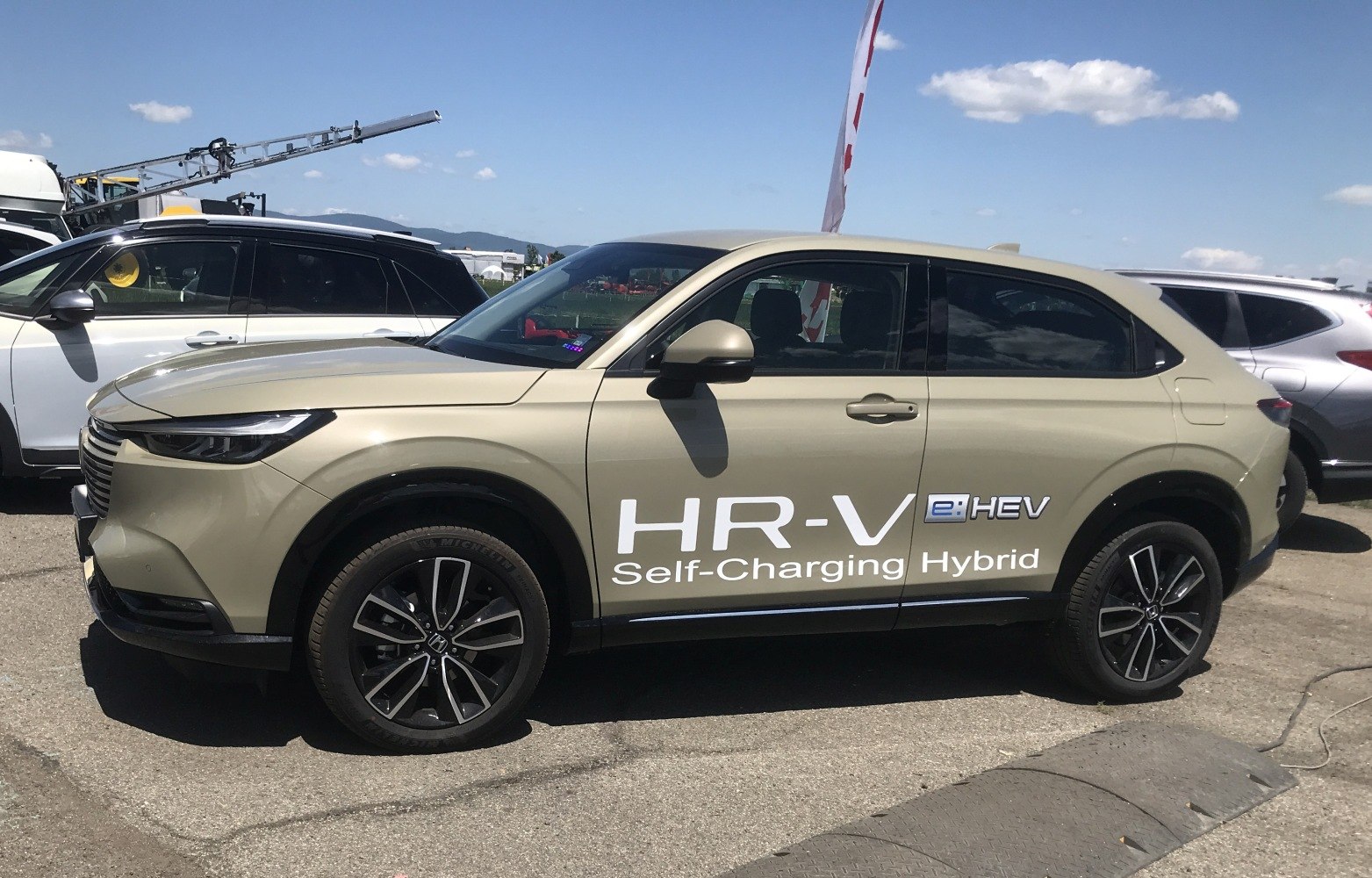 Side profile of a self-charging hybrid SUV with sleek design and alloy wheels