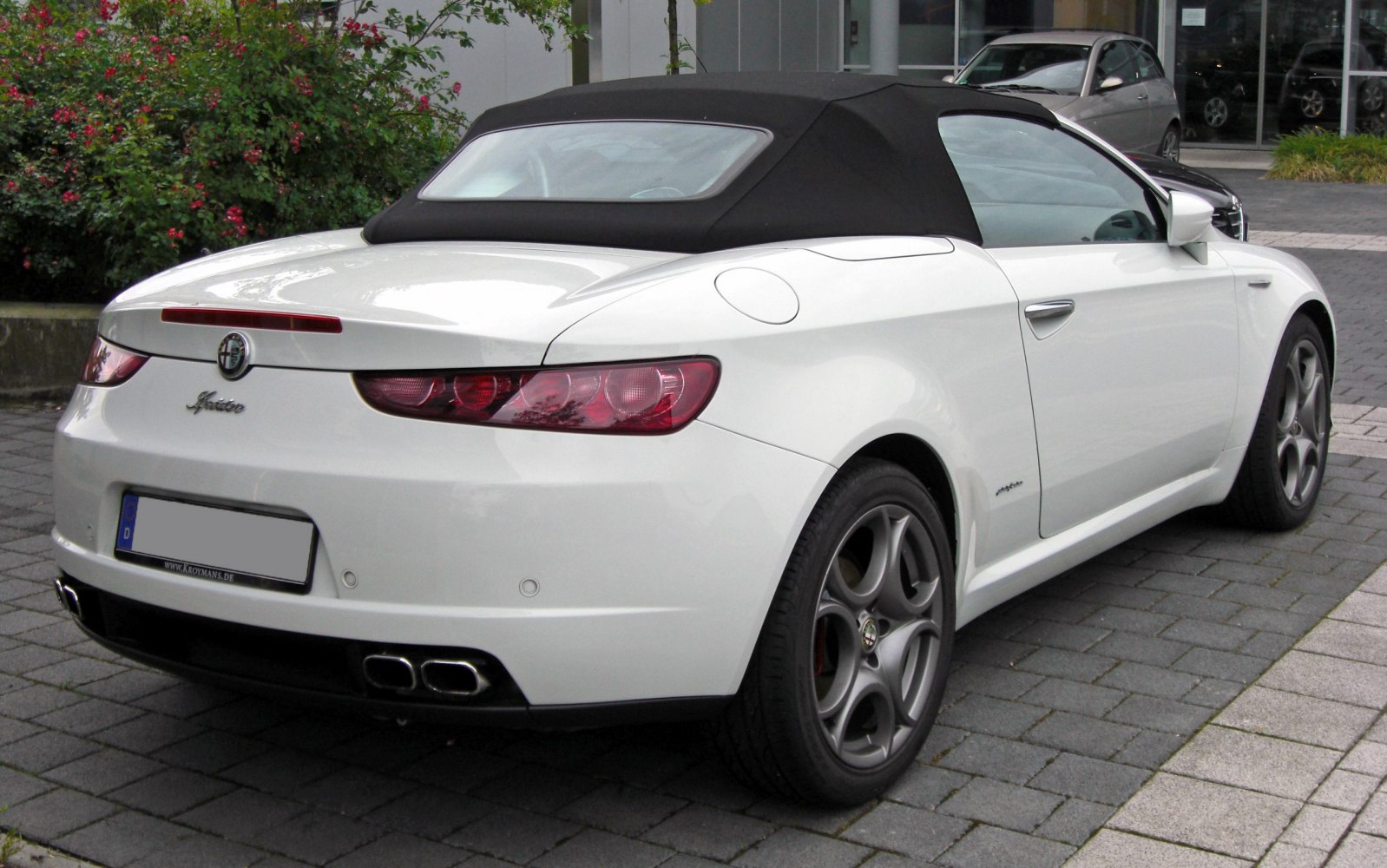 Rear view of convertible with black soft top and distinctive taillights