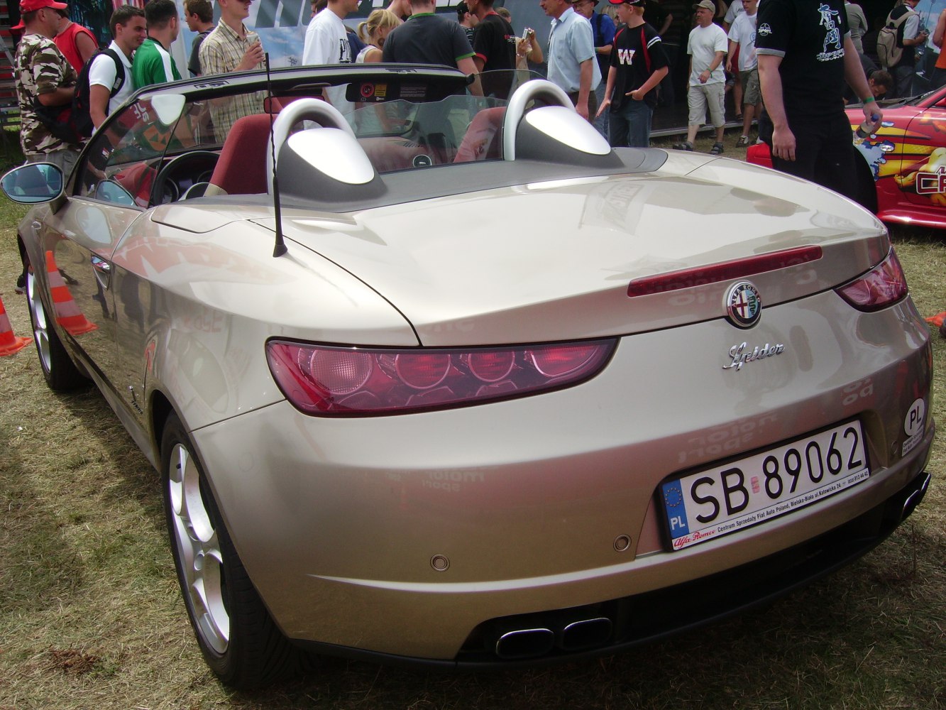 Rear view of convertible showing tail lights and dual exhaust