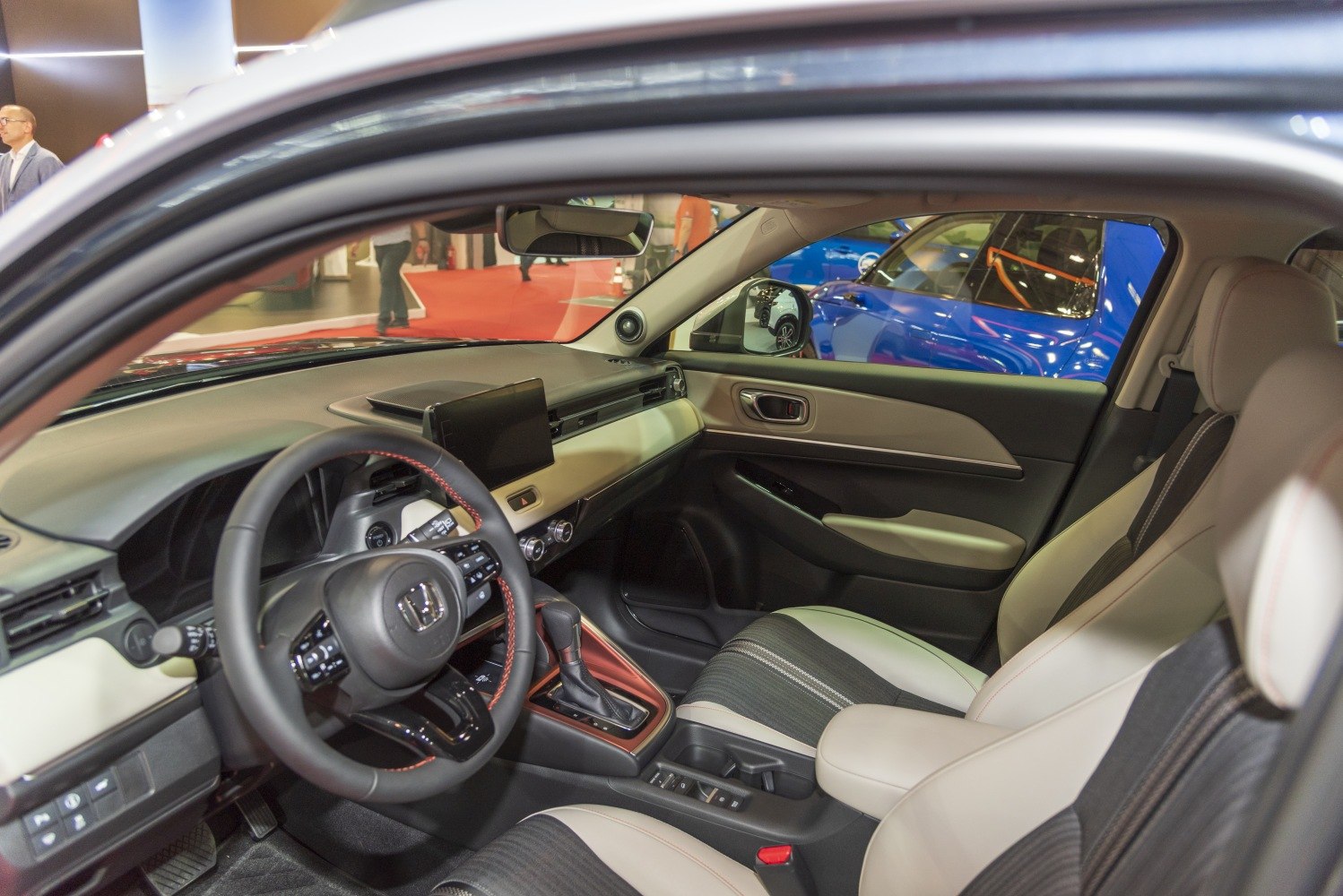 Modern interior with dashboard, touchscreen display, and stylish seats