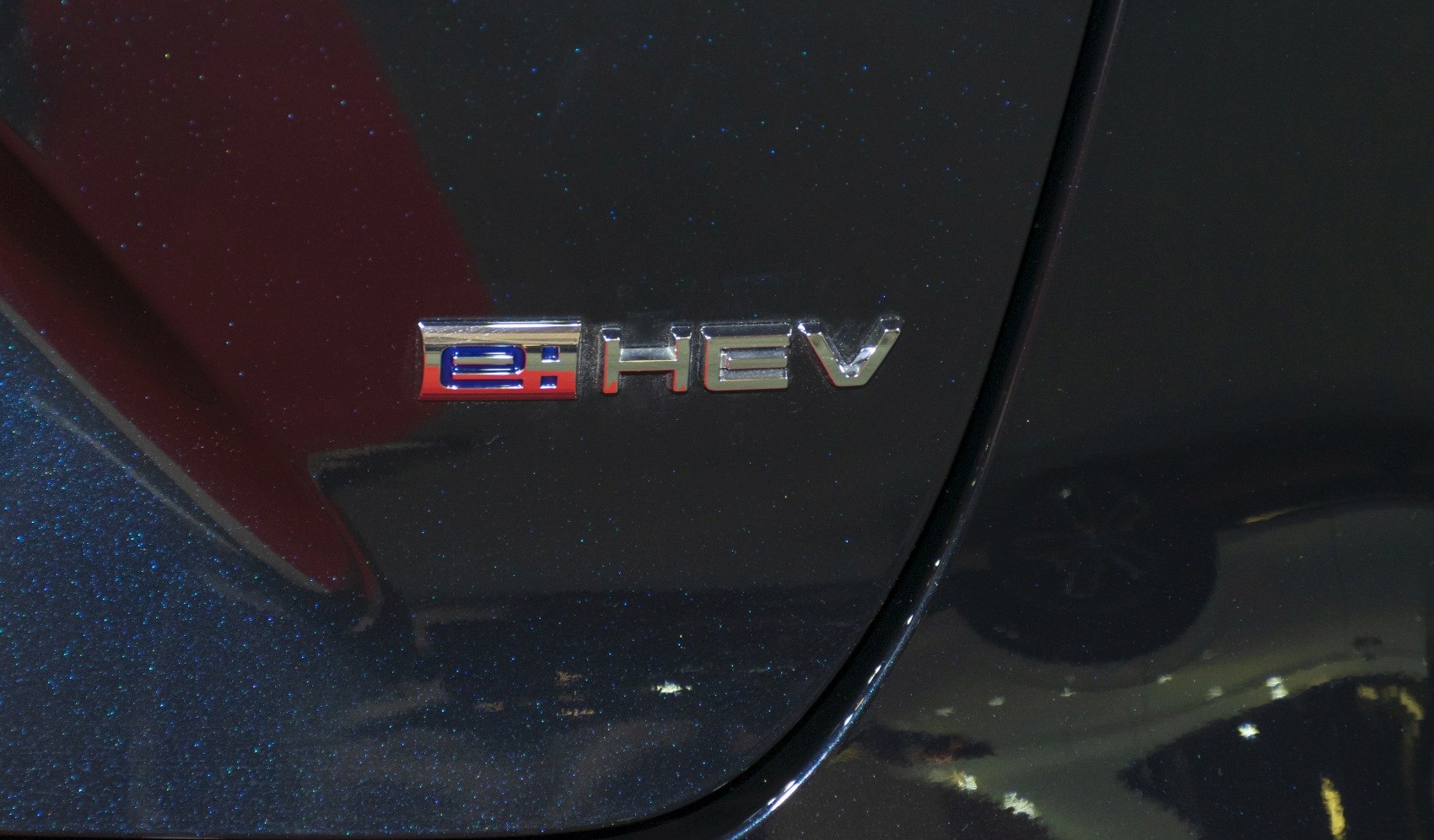 e:HEV badge emblem on vehicle body surface
