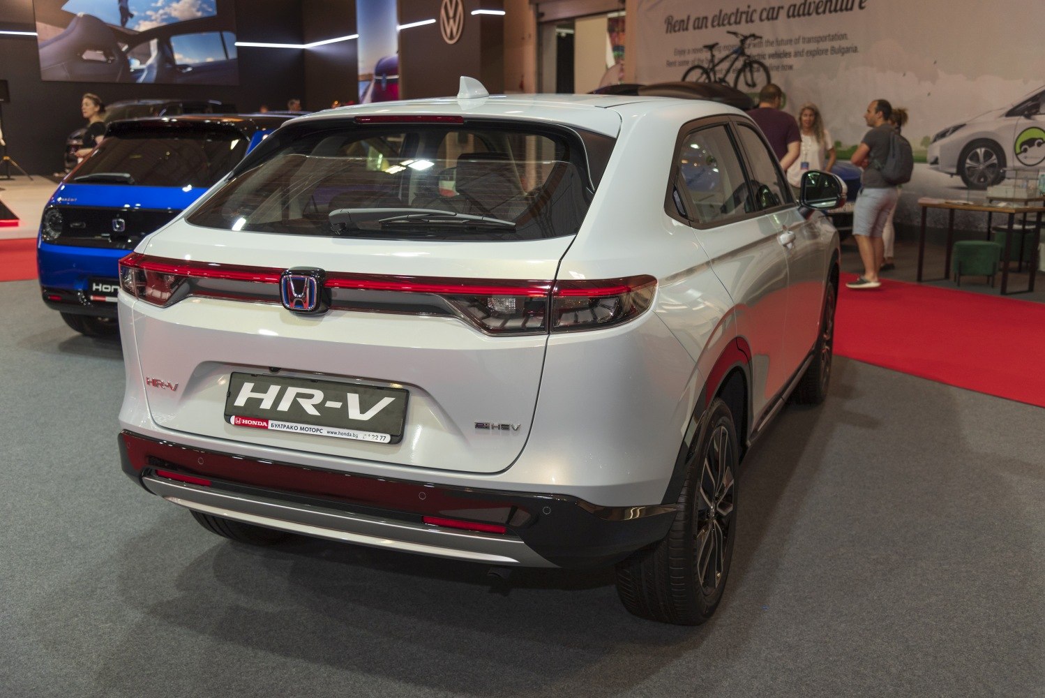 Rear view showing LED strip taillights and hybrid badge