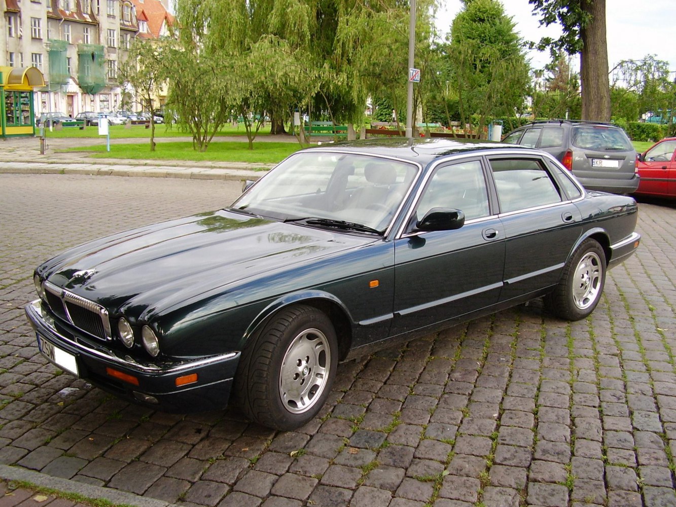 Front three-quarter view of classic sedan with round headlights and chrome grille