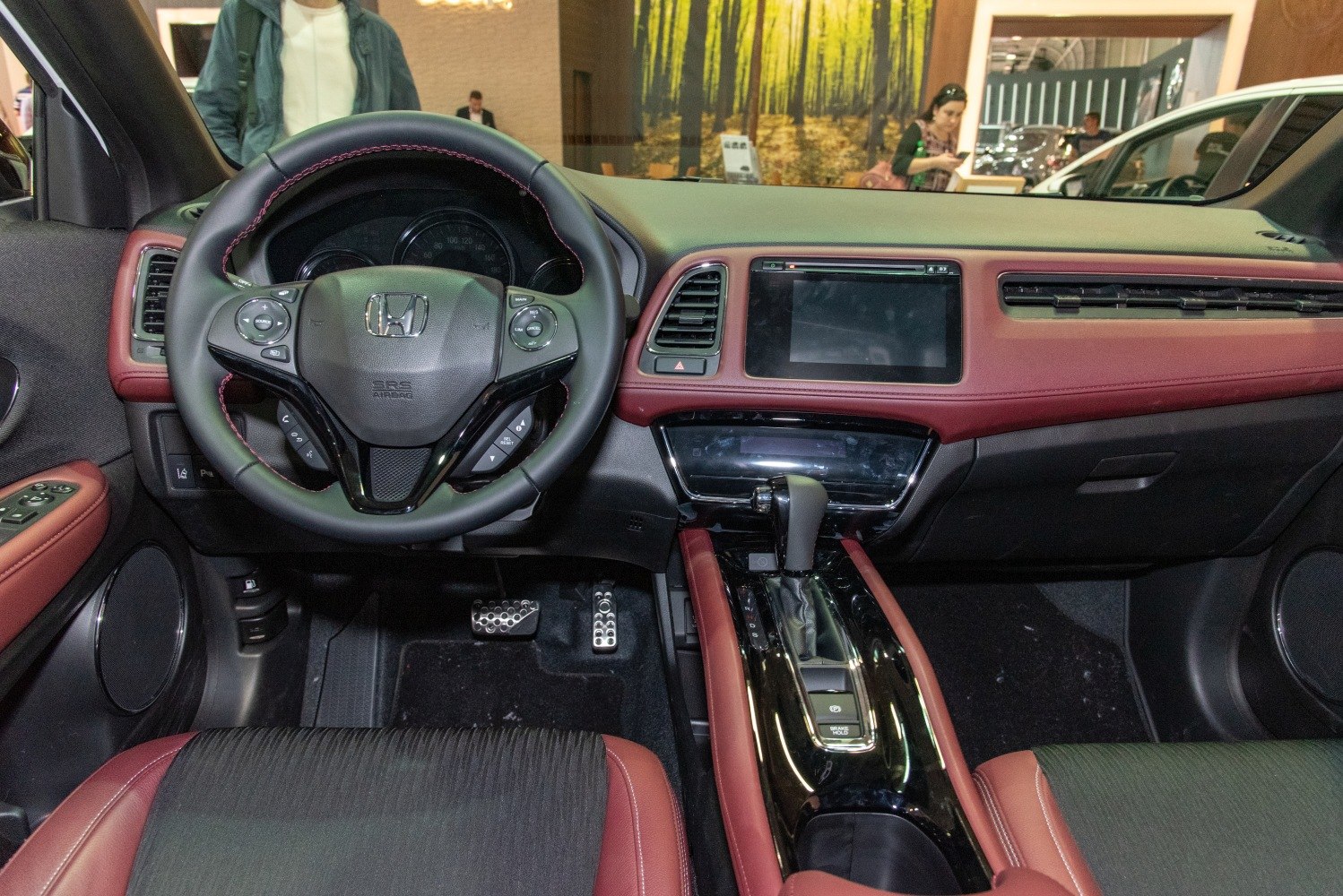 Steering wheel with controls and center console with touchscreen and gear shifter