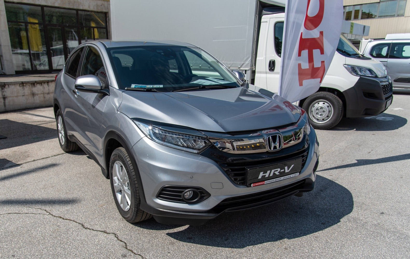 Silver SUV with LED headlights and chrome grille, front view