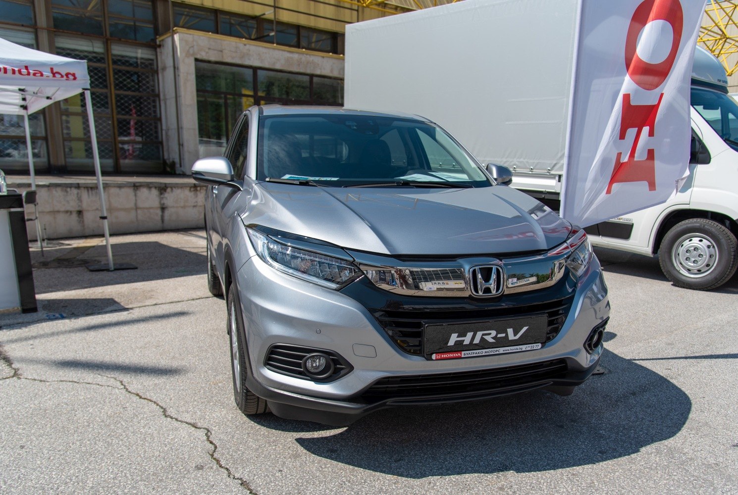 Silver compact SUV with LED headlights and chrome grille front view.