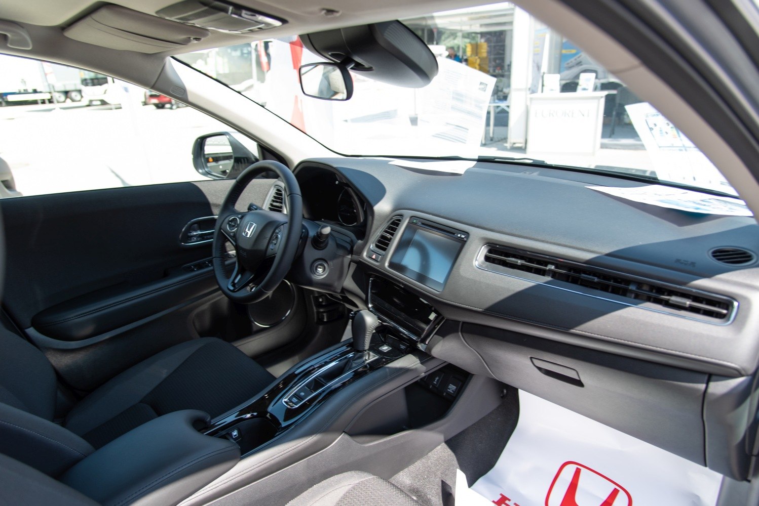 Modern dashboard and steering wheel with center console and gear shift