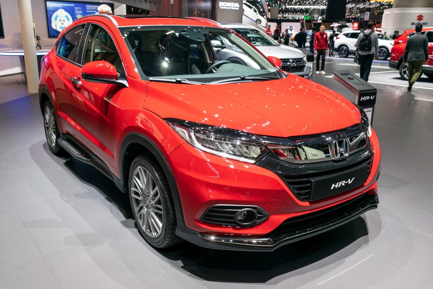 Red SUV front side view with sleek headlights and sporty design