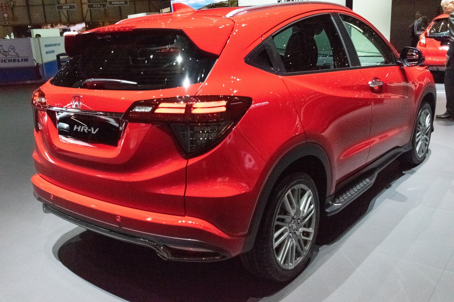 Rear and side view of red compact crossover with distinct tail lights and alloy wheels