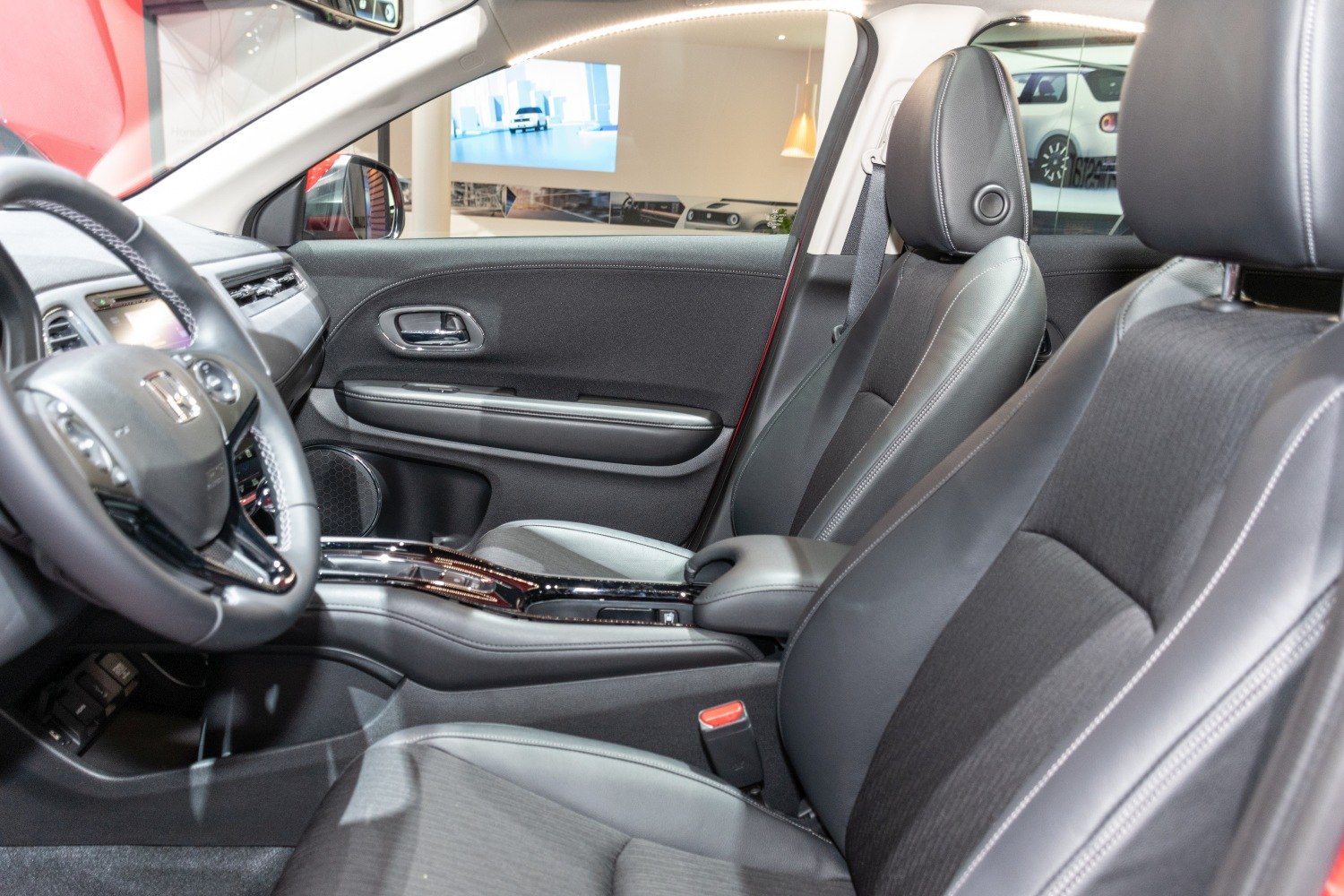 Black leather and fabric front seats with modern door panel and dashboard