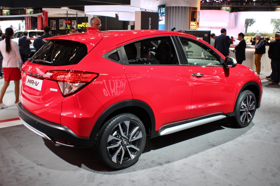Rear side view of red compact SUV with alloy wheels and sporty design