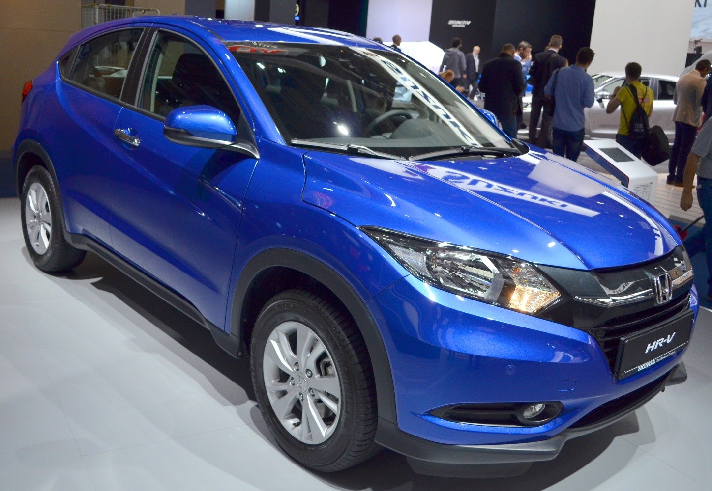 Blue compact SUV front three-quarter view with headlights and alloy wheels