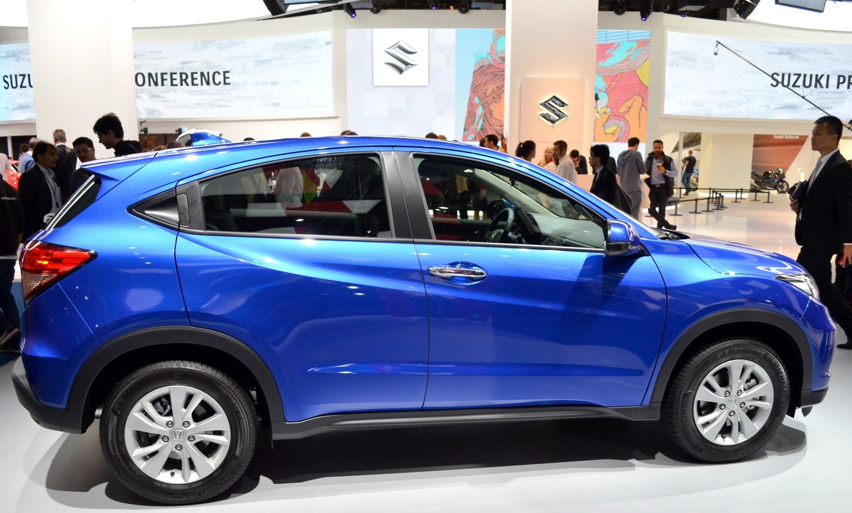 Side profile of blue compact SUV with alloy wheels