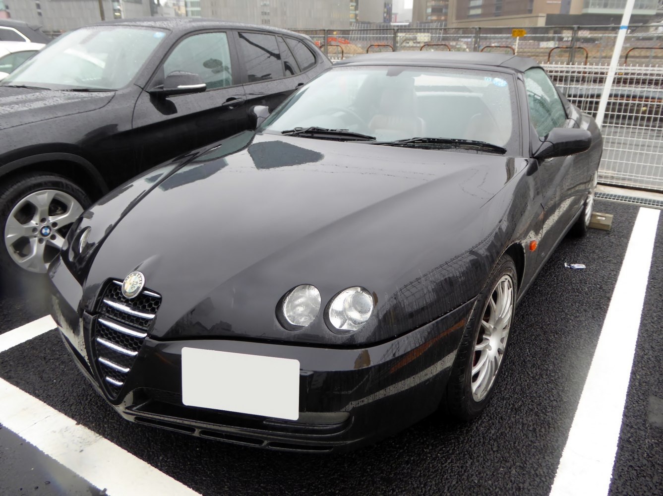 Sleek front end with dual round headlights and distinctive grille.