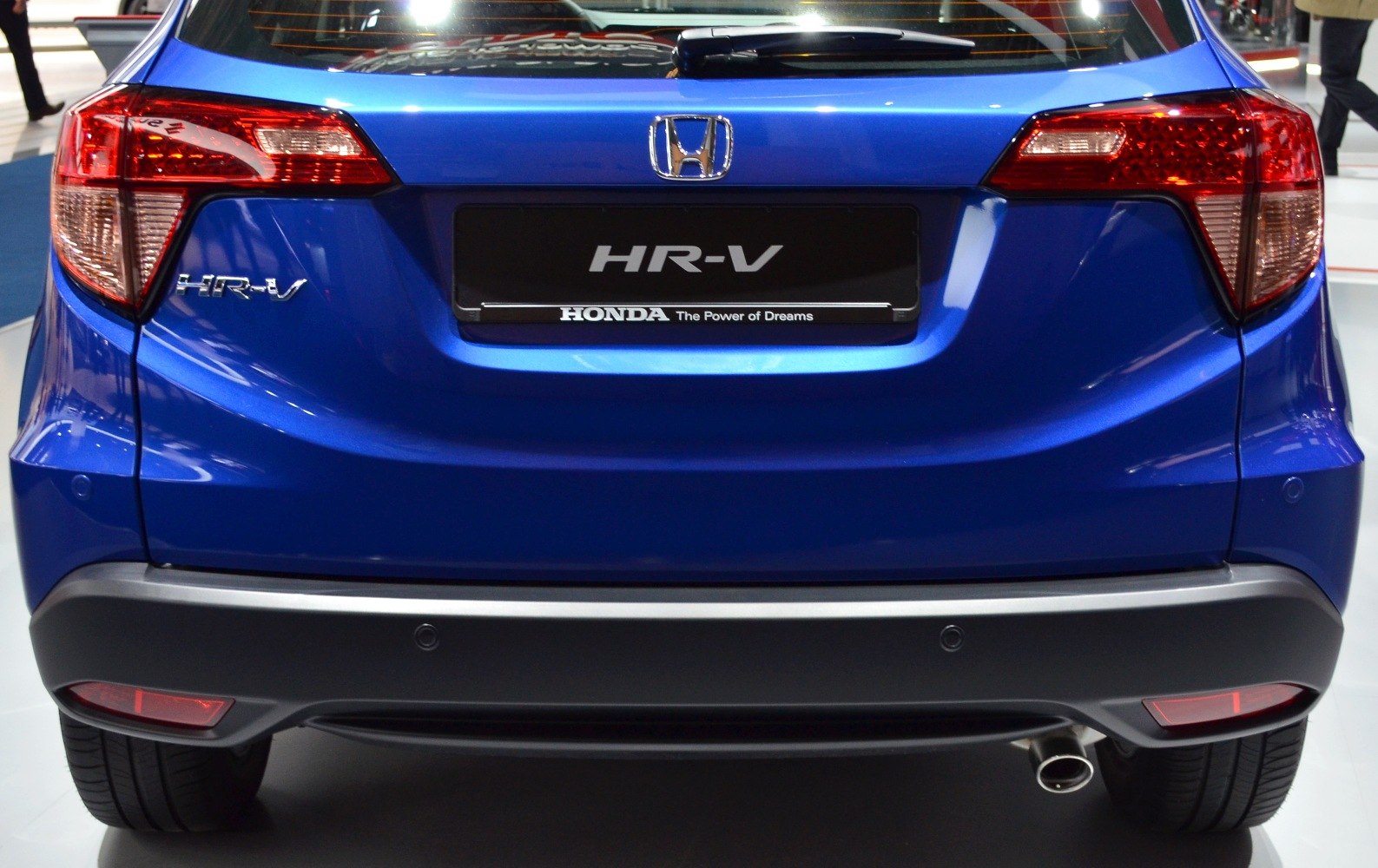 Close-up of rear taillights, exhaust pipe, and bumper