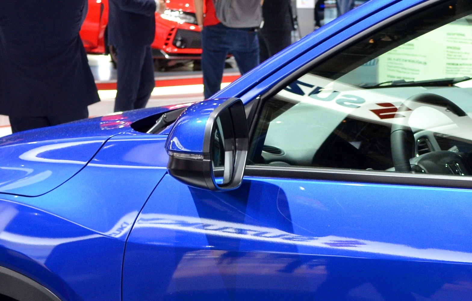 Close-up of side mirror and door panel on a blue vehicle