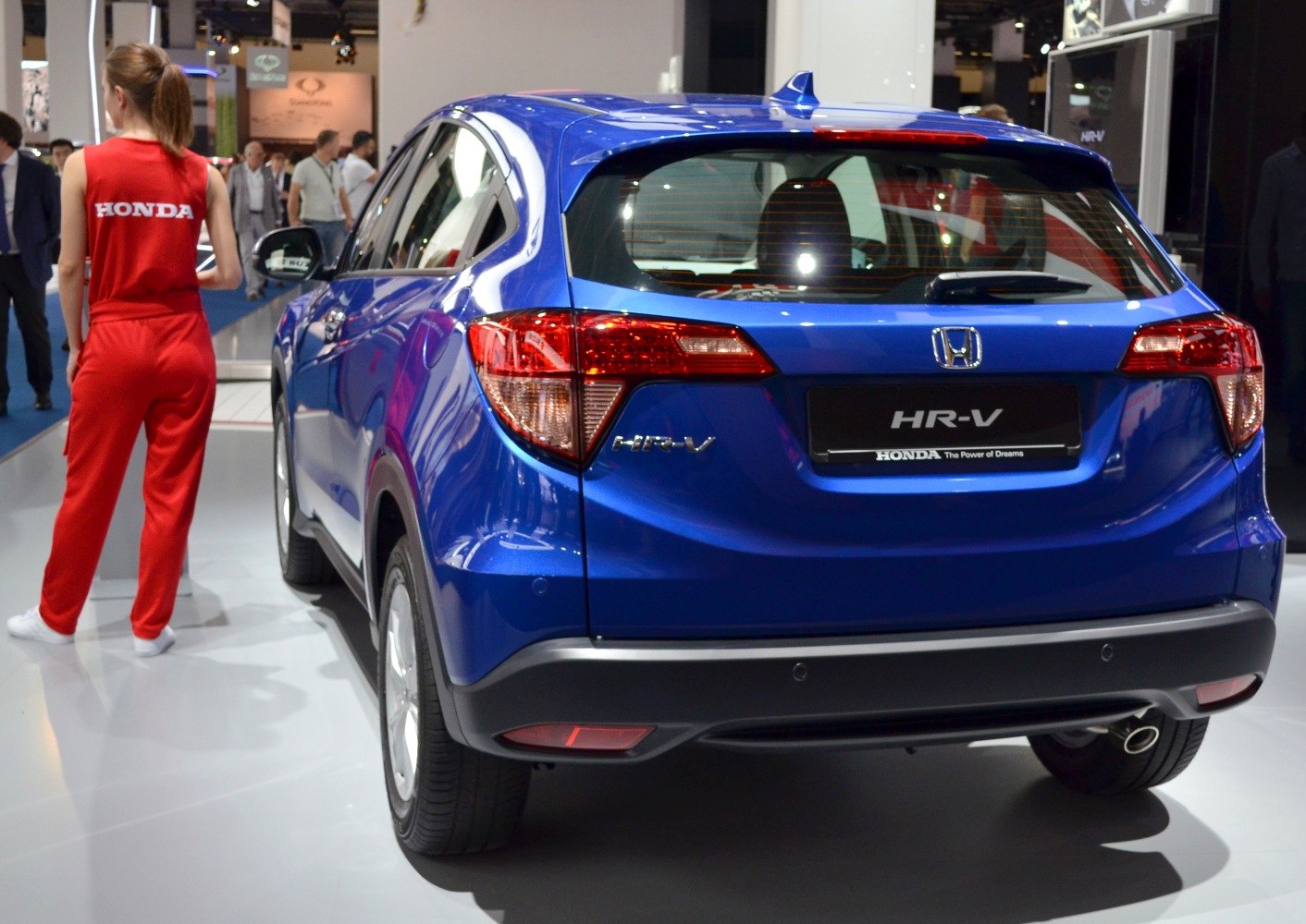 Rear view of blue compact SUV with tail lights and exhaust pipe