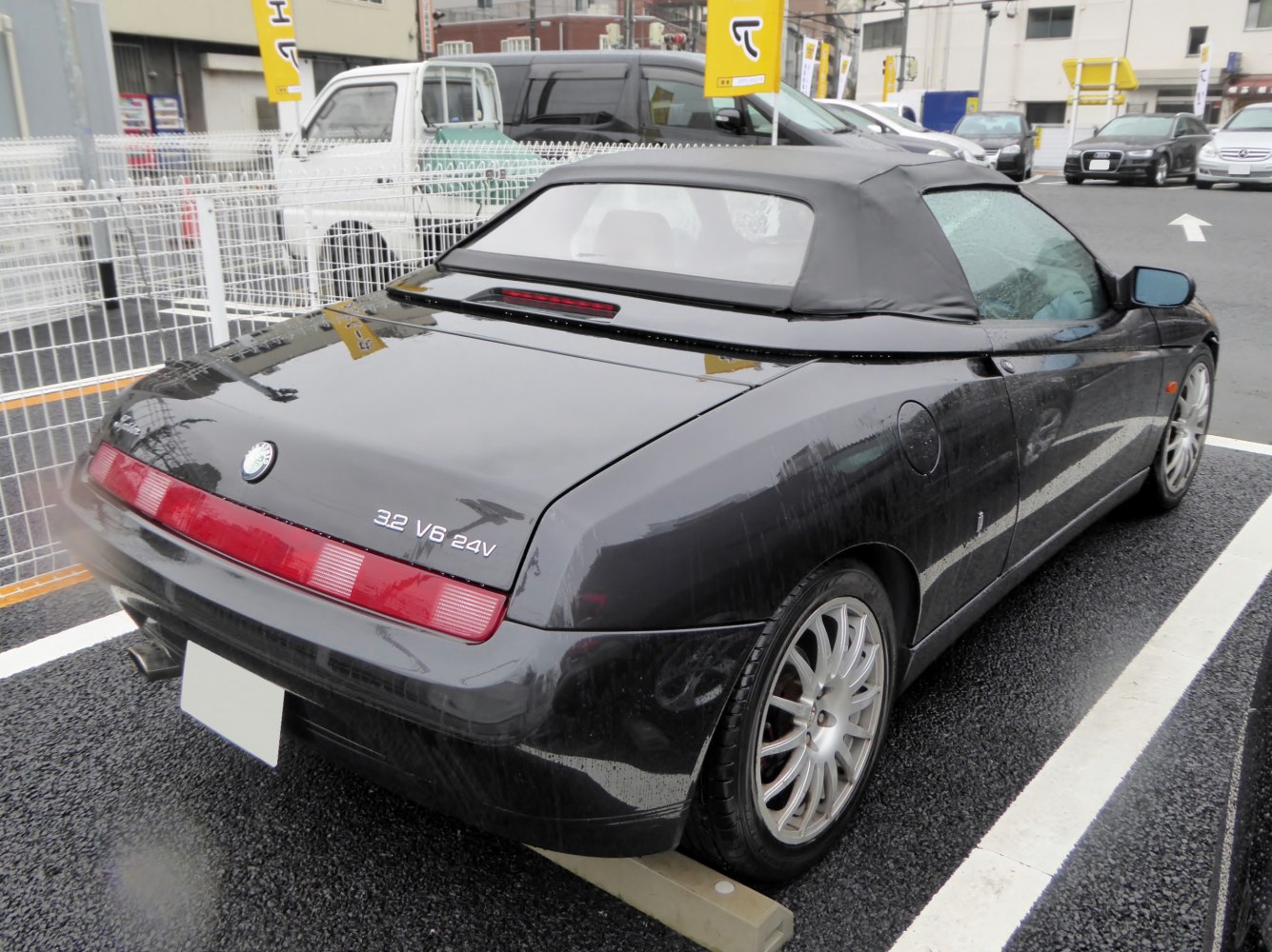 Rear view of convertible with soft top and 3.2 V6 24V engine badge