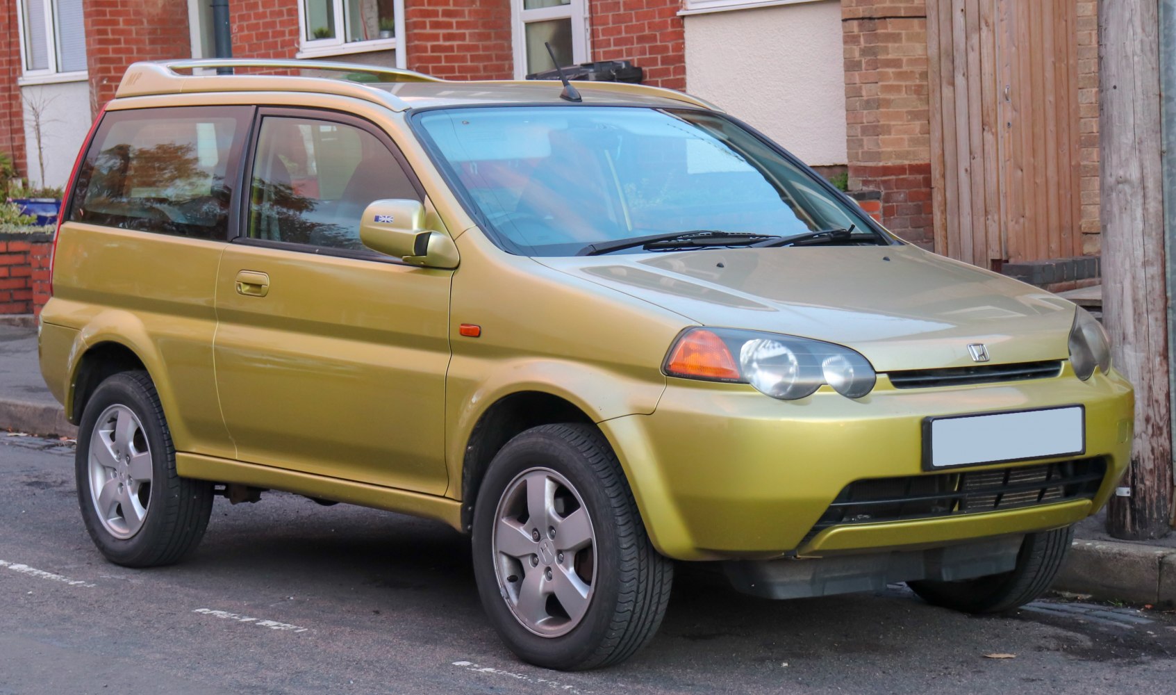 Compact SUV with round headlights and roof rails