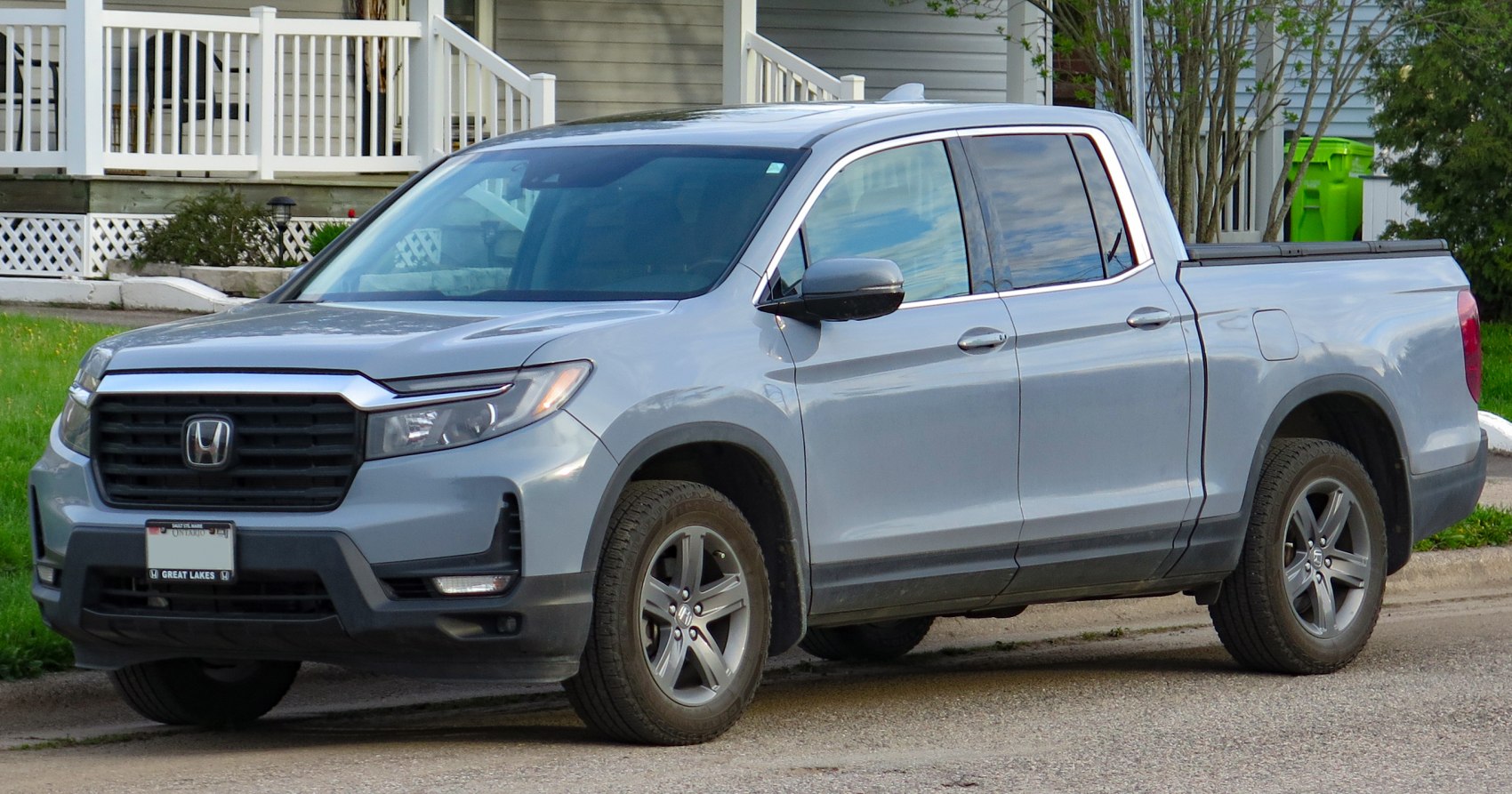 Front and side view of modern pickup with grille and dual cab
