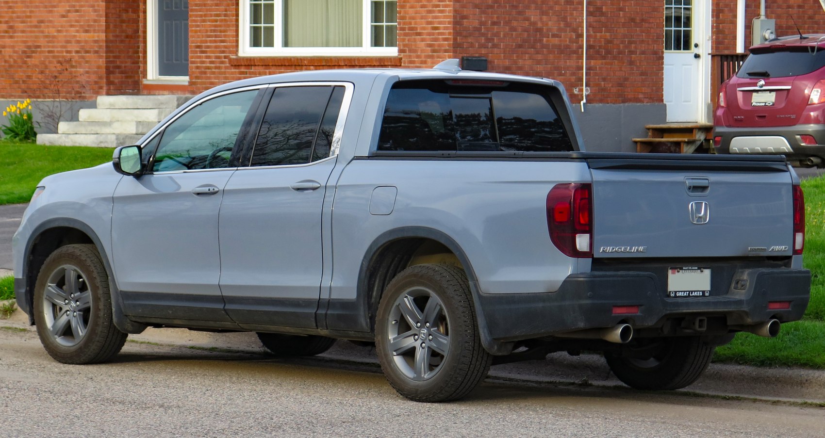 Rear side view of modern pickup truck with dual exhaust and tinted rear windows