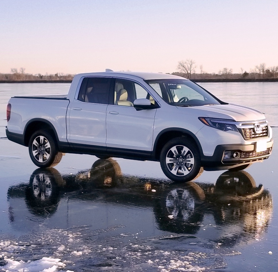 Pickup truck side profile with crew cab and alloy wheels.