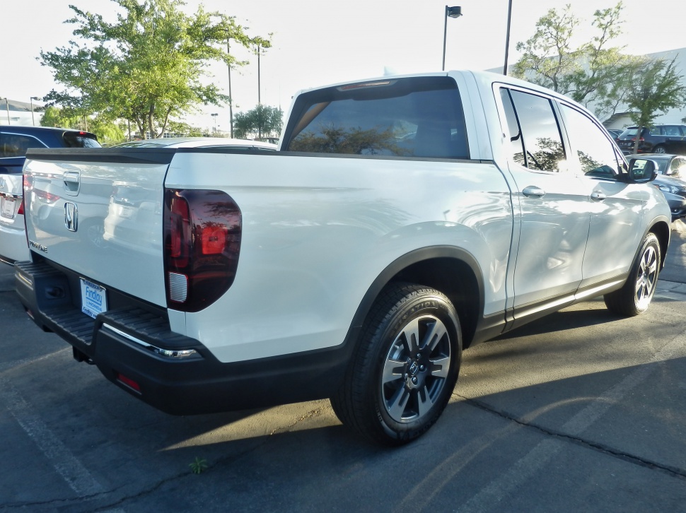 White pickup truck rear and side view with tinted windows and black trim
