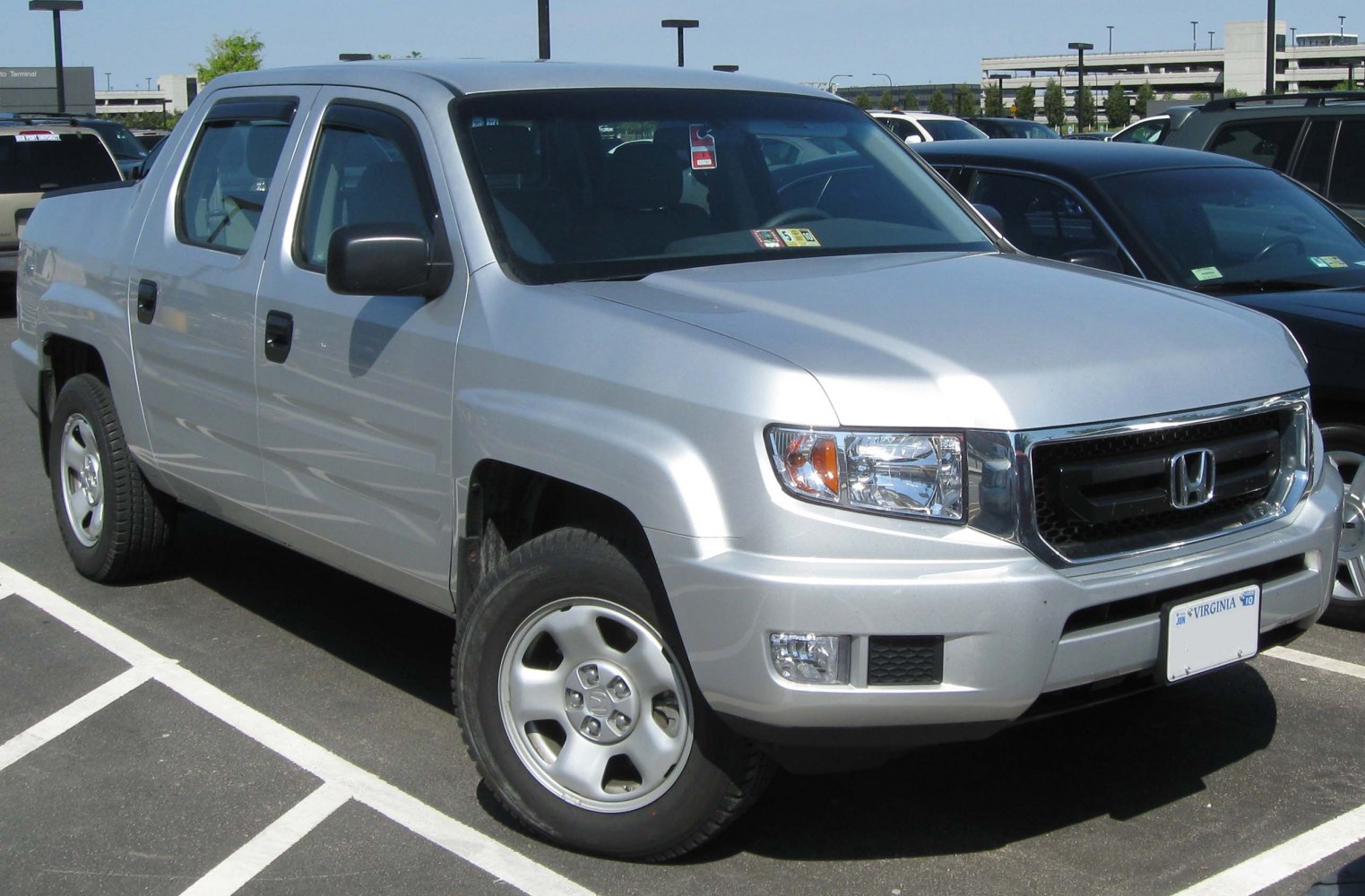 Silver pickup truck with front grille and side profile