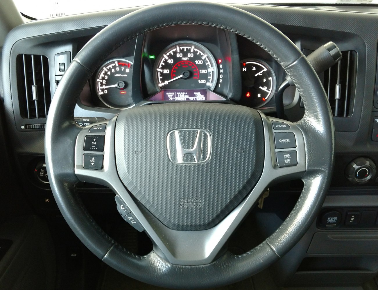Steering wheel with control buttons and instrument cluster
