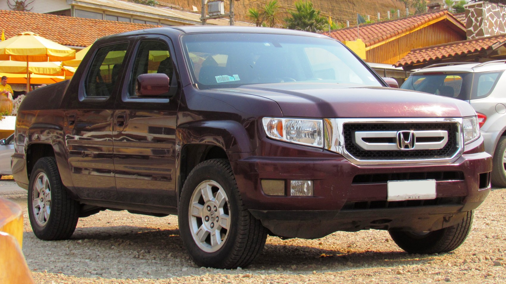 Front side profile of pickup with alloy wheels and prominent grille