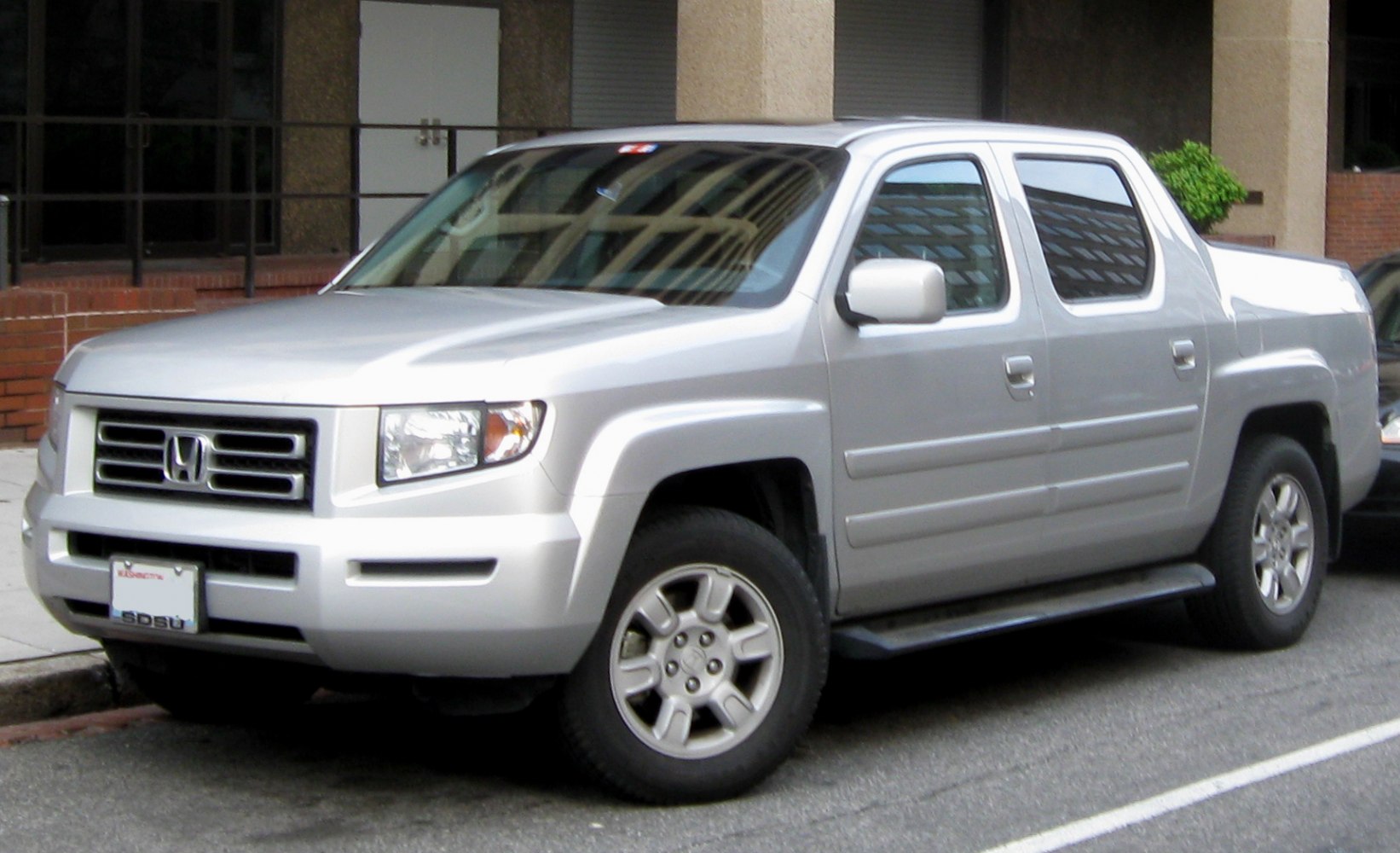 Side view of silver midsize pickup with alloy wheels