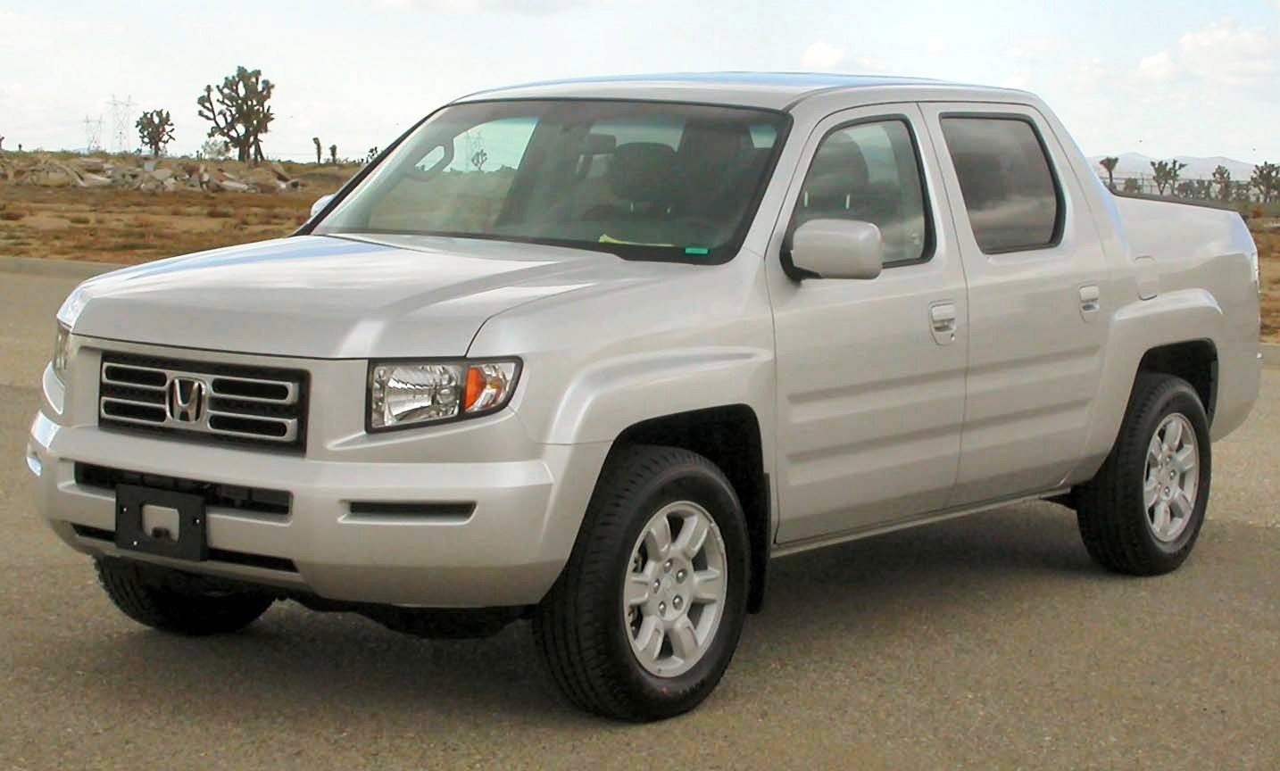 Front-side view of silver pickup with crew cab and boxy styling