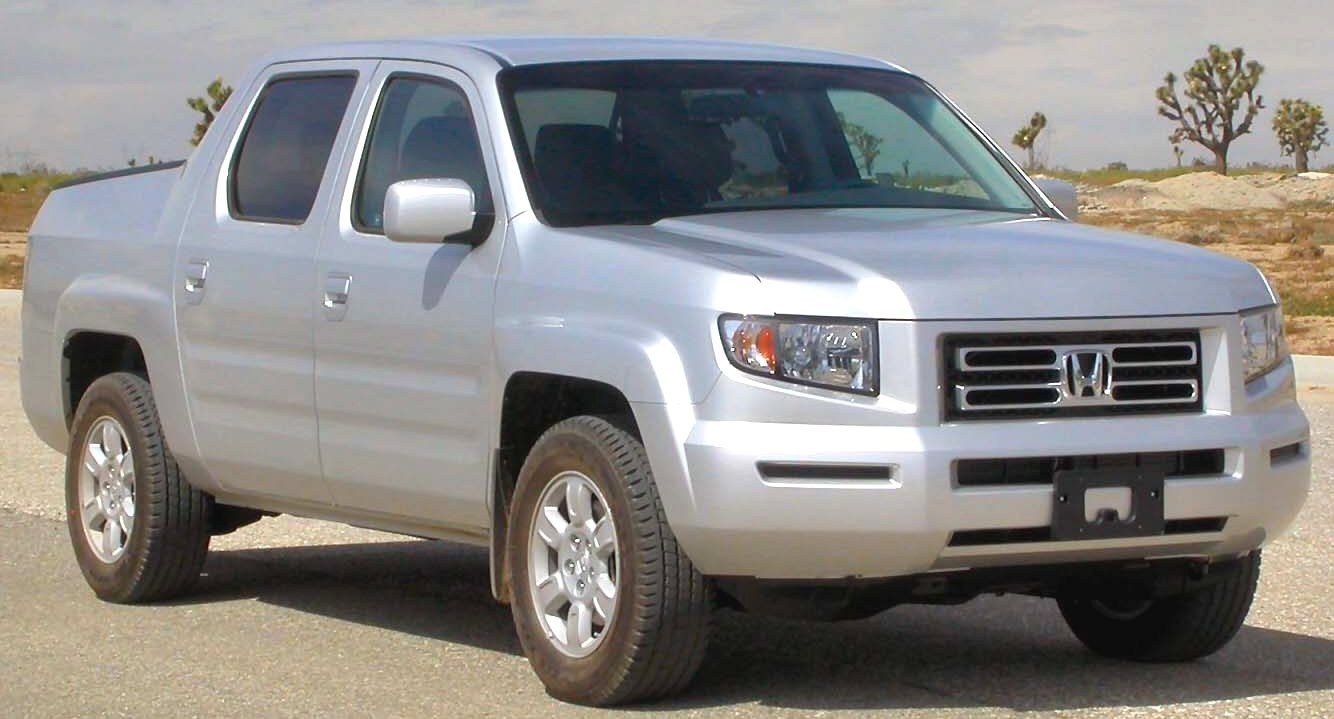 Silver double cab pickup truck with distinctive front grille and alloy wheels