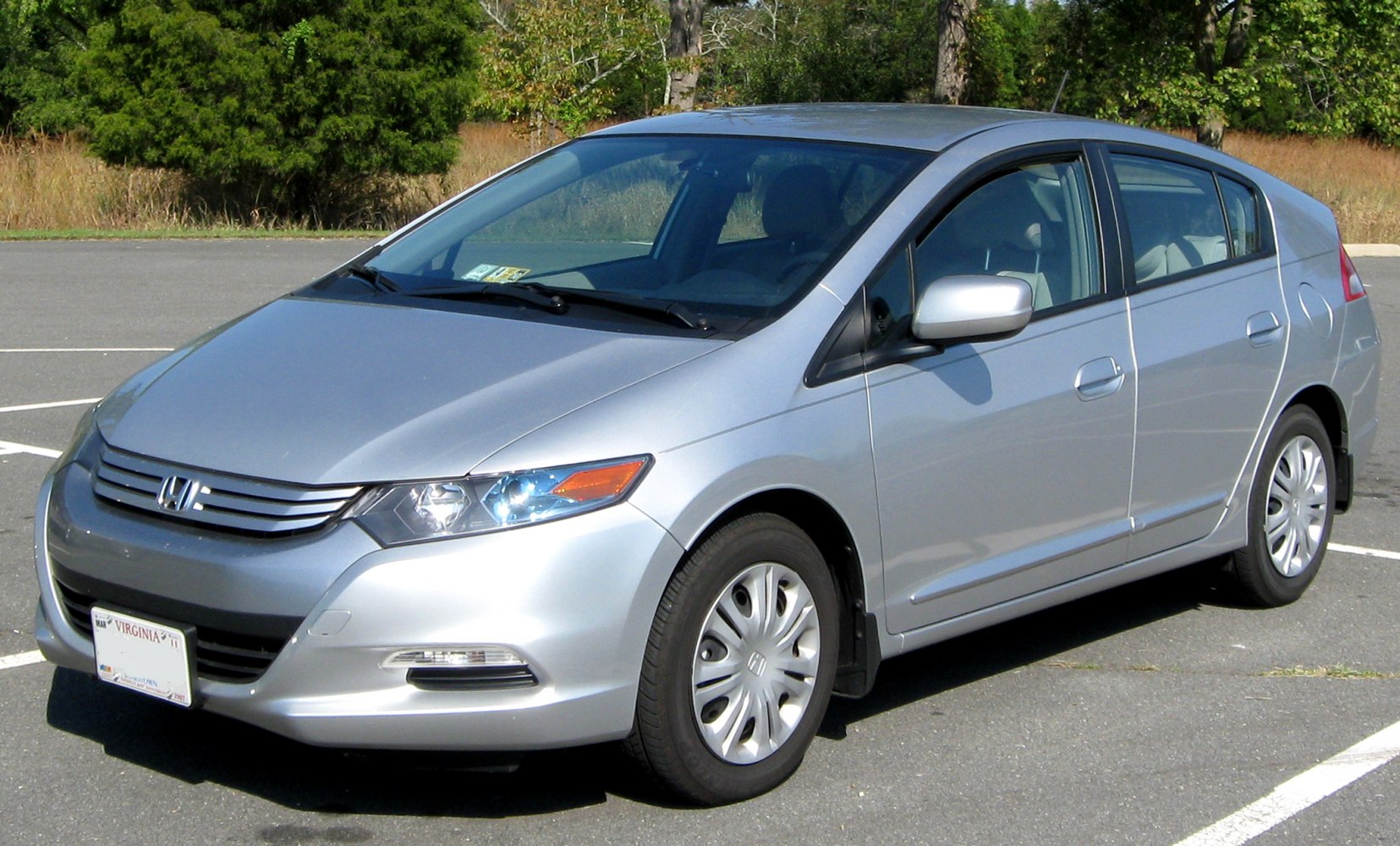 Silver compact hybrid sedan front side with aerodynamic design