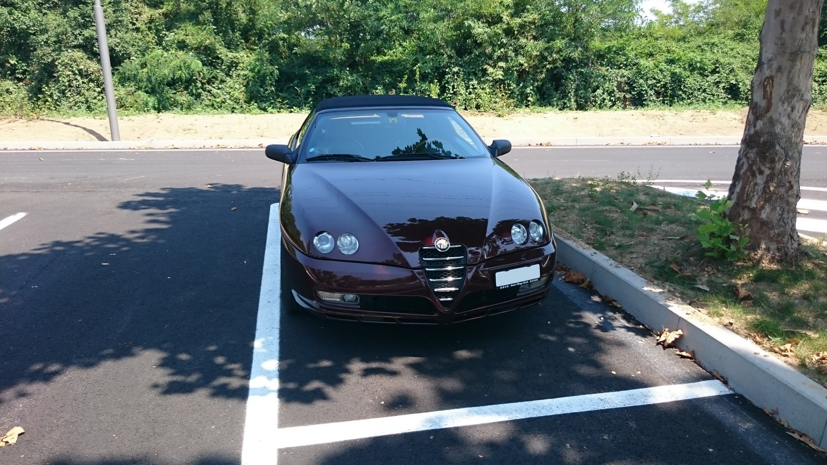 Front view of car with dual round headlights and signature grille