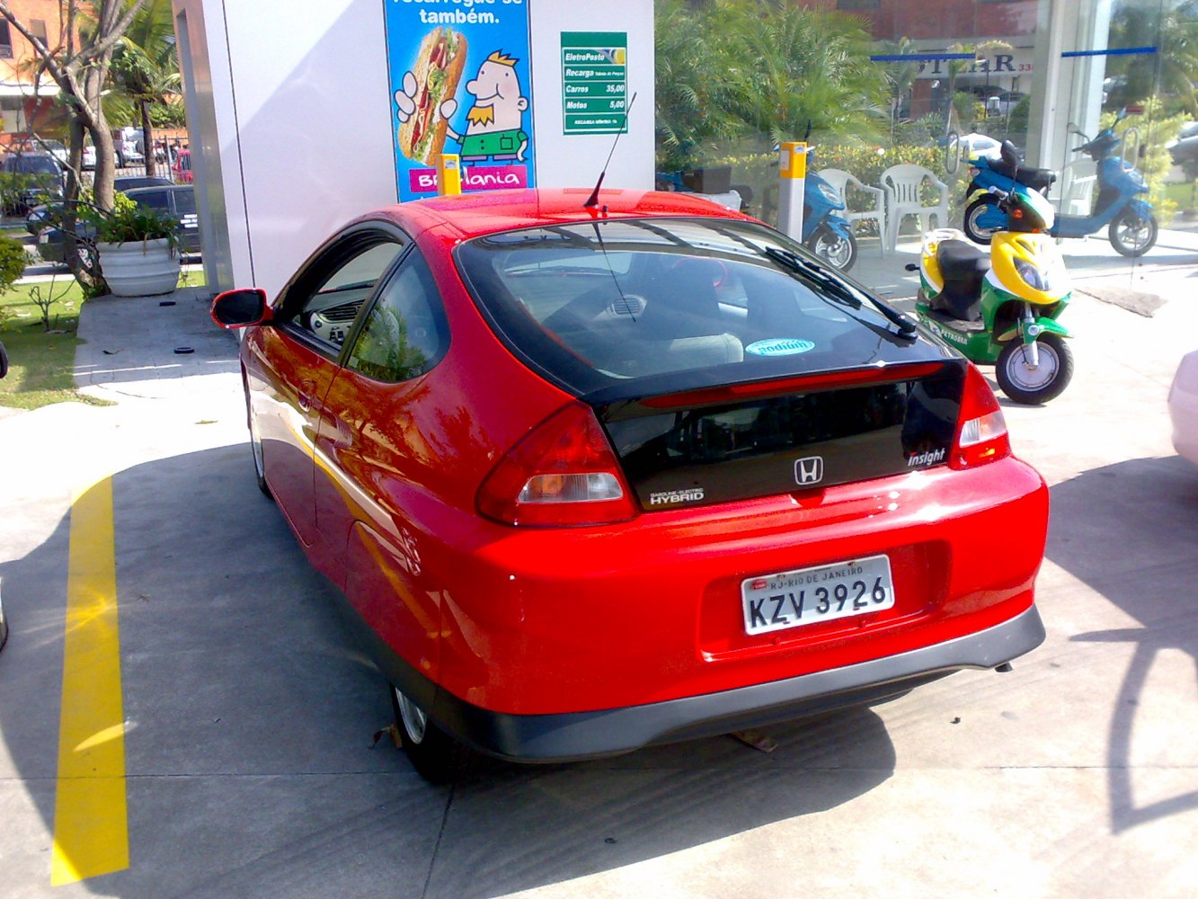 Red hybrid hatchback with rear spoiler and rear window wiper
