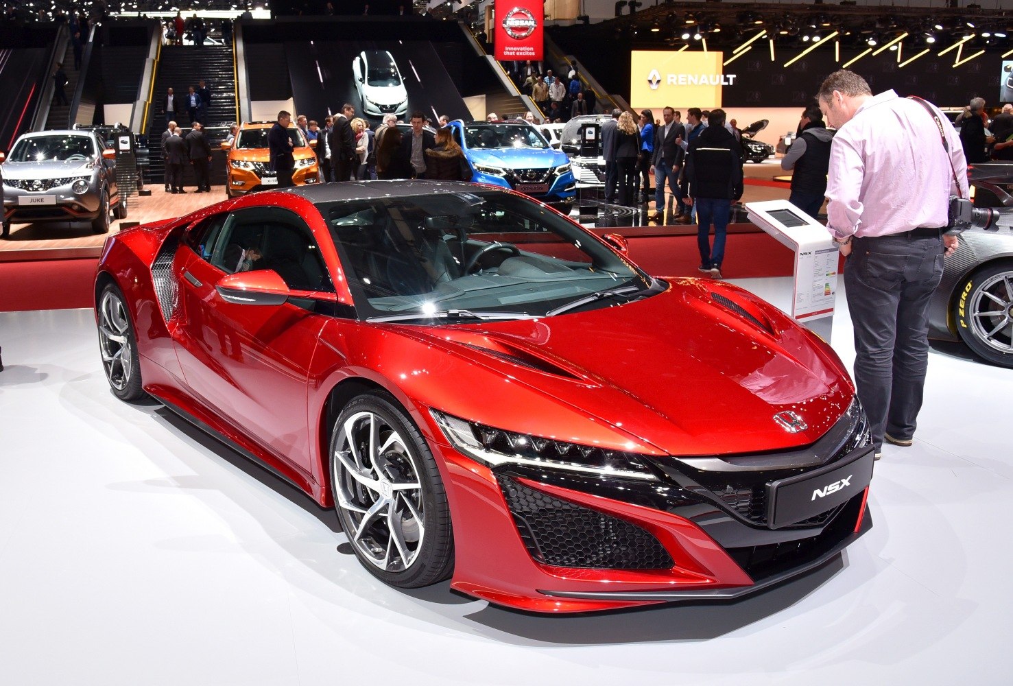 Red sports coupe with sharp front design and alloy wheels
