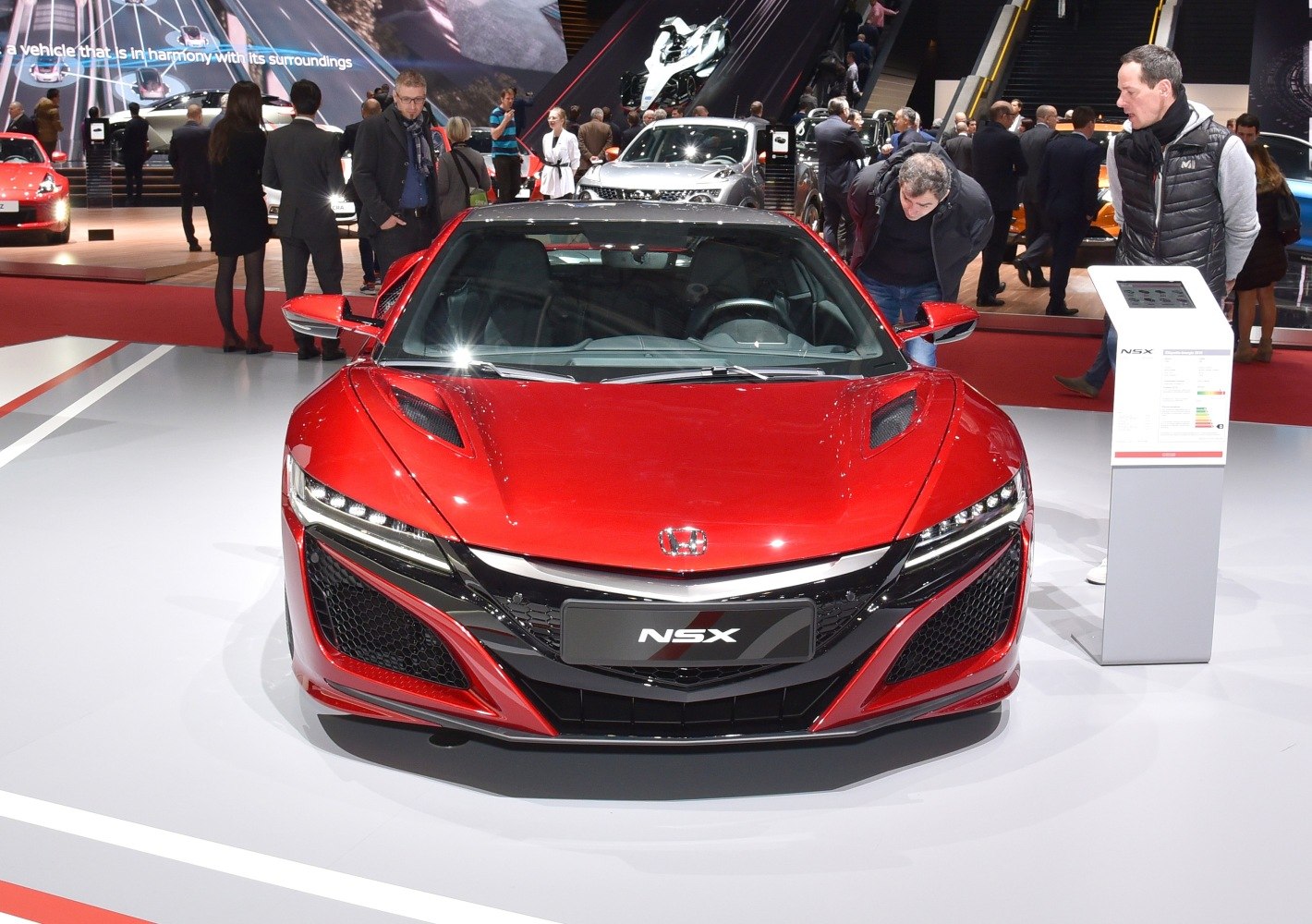 Sporty red front view with aggressive grille and sleek headlamps
