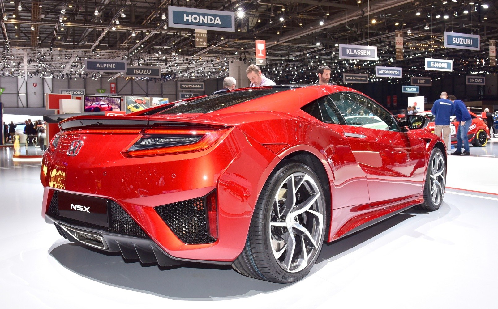 Rear view of a red sports coupe with alloy wheels and distinctive taillights
