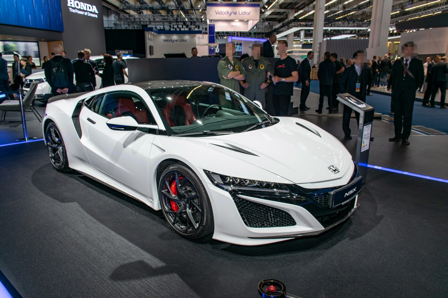 White sports coupe with aerodynamic vents and red brake calipers