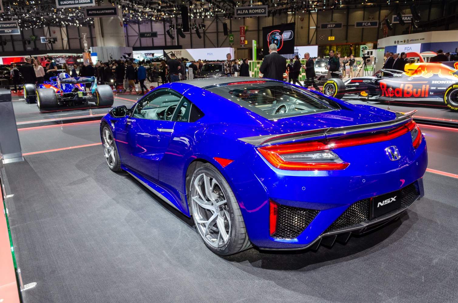 Rear view of a blue 2016 sports coupe with modern taillights and diffuser