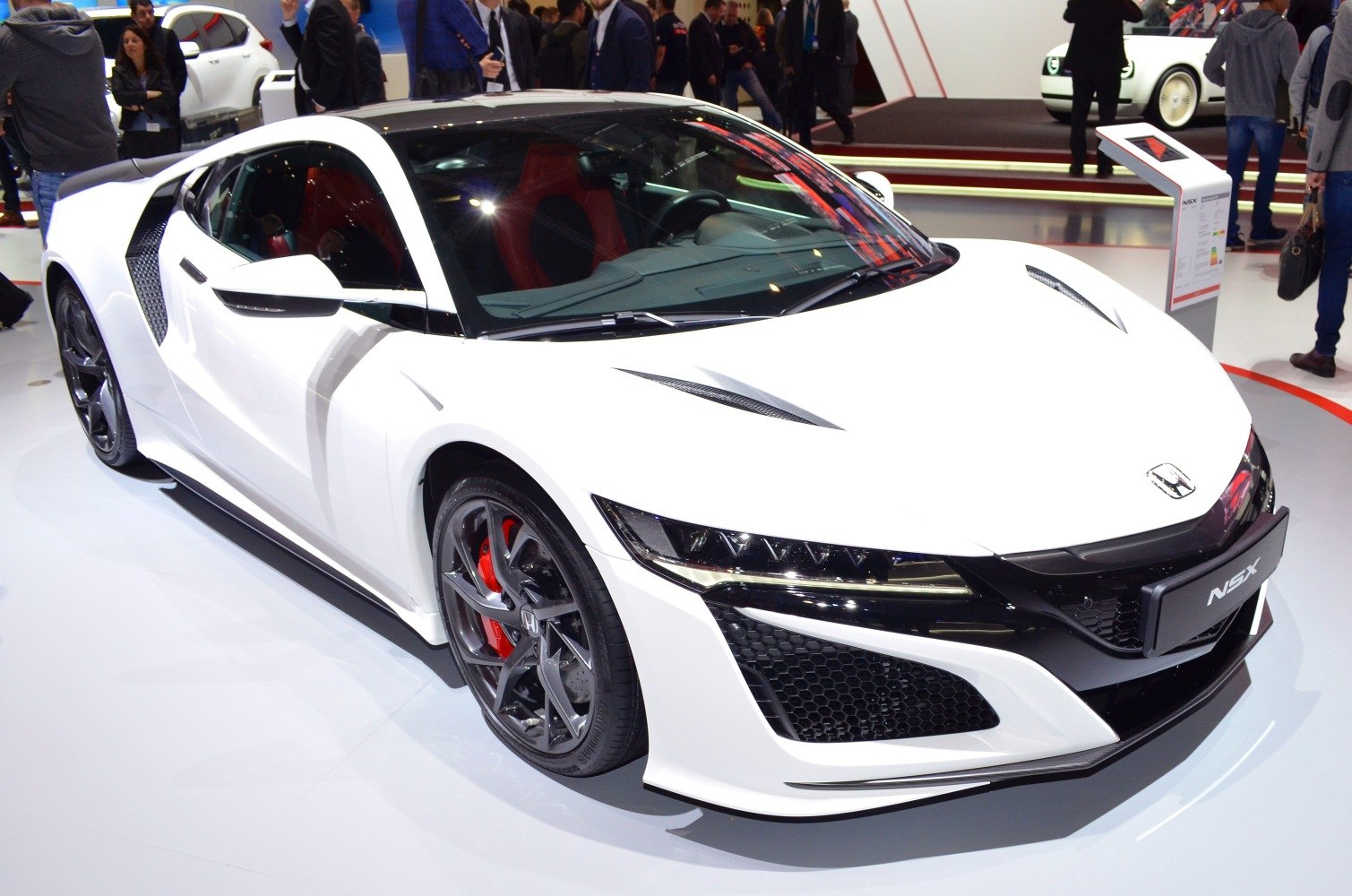 Aerodynamic white sports coupe with LED headlights and red brake calipers