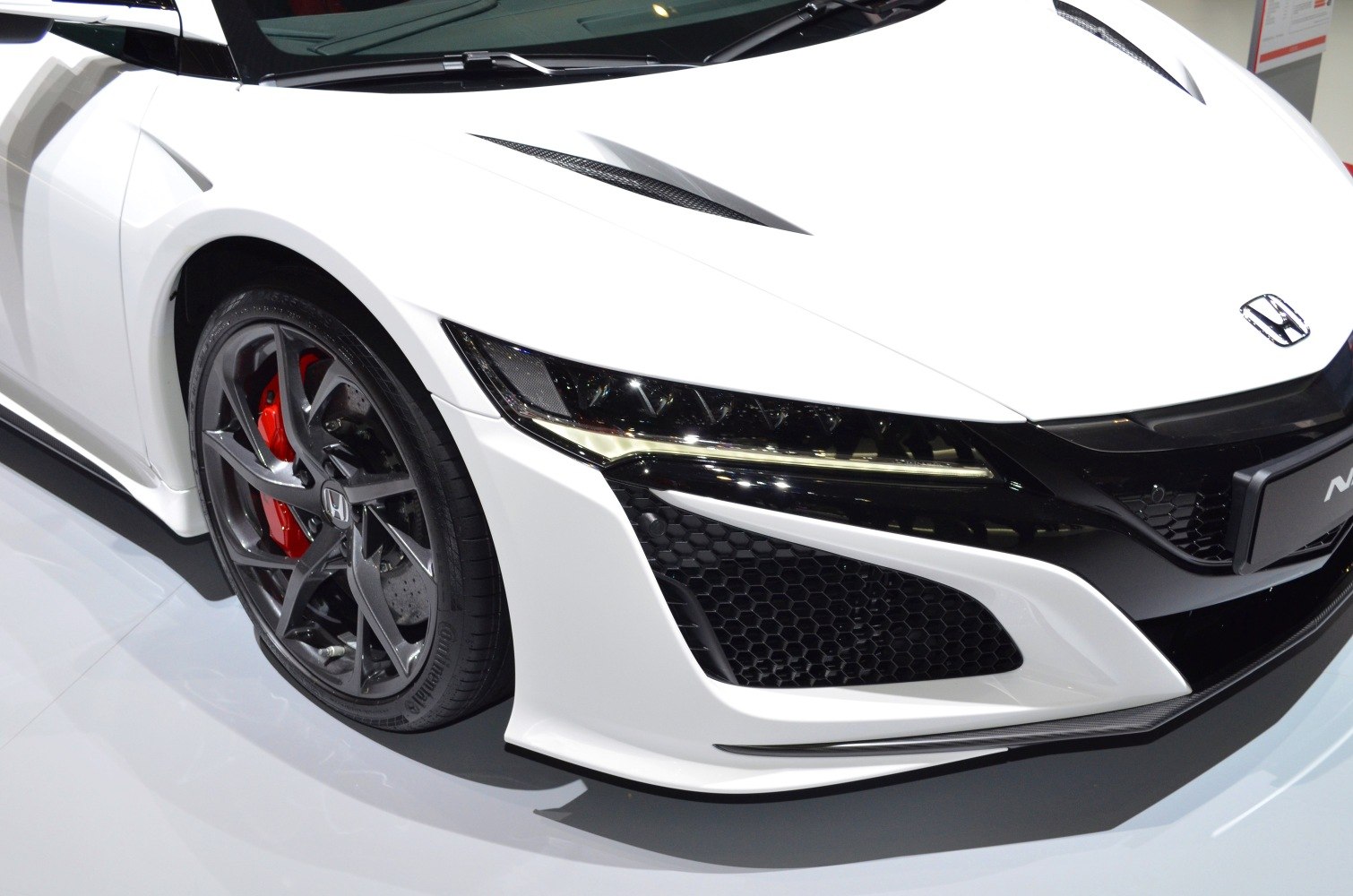 Front headlight with LED lights and black alloy wheel with red brake caliper
