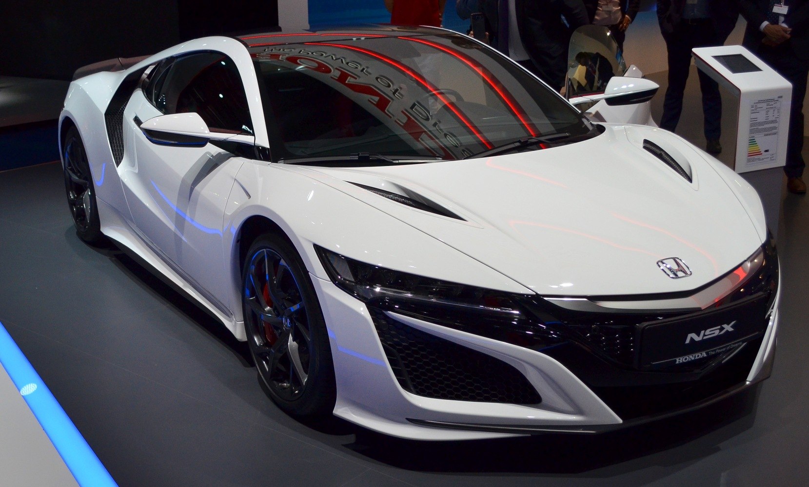 White sports coupe with aerodynamic design and vented hood