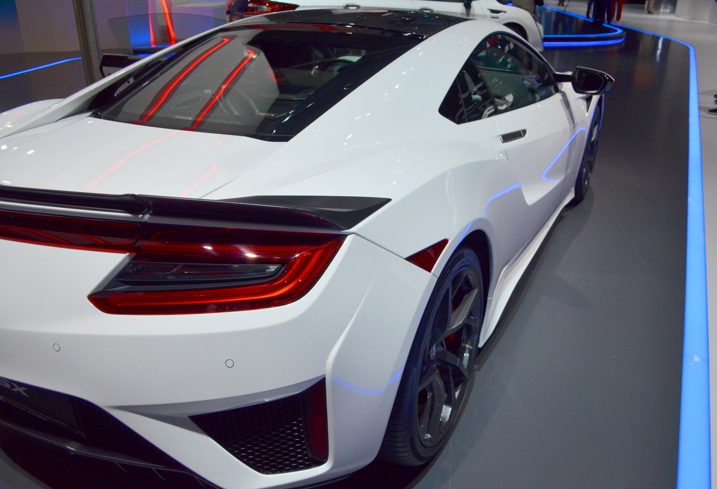 Rear view with tail lights and aerodynamic curves of a modern sports coupe