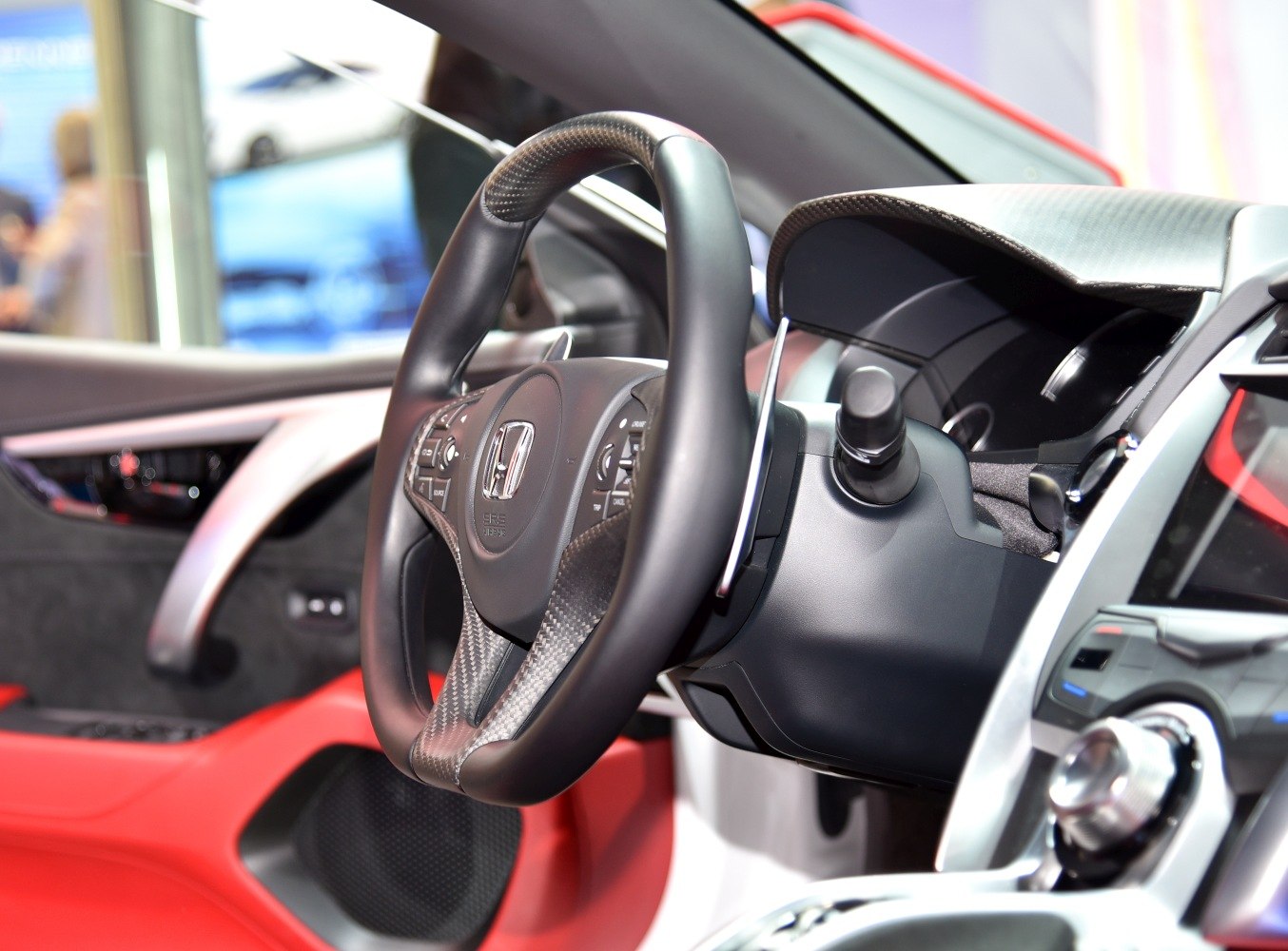 Flat-bottom steering wheel with carbon fiber and detailed dashboard controls