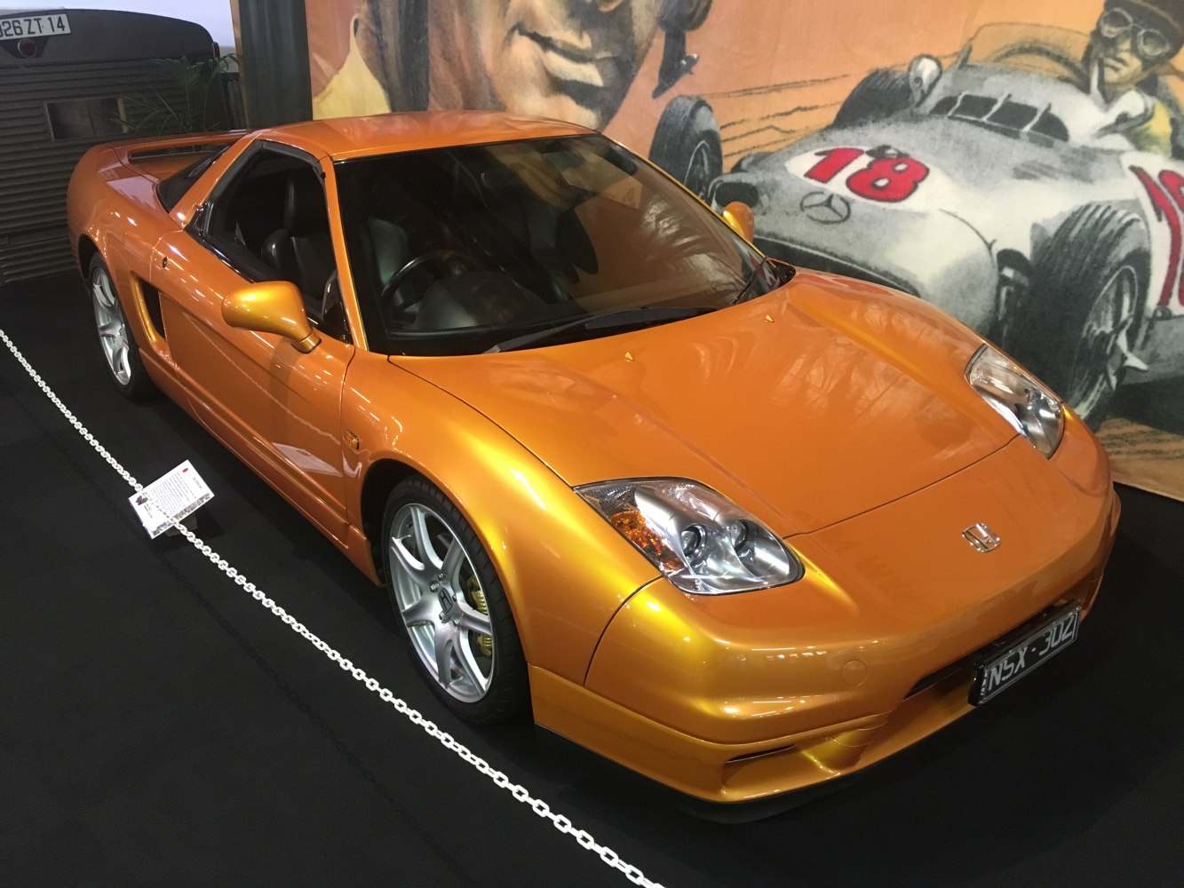 Orange sports coupe with aerodynamic design and distinct headlights